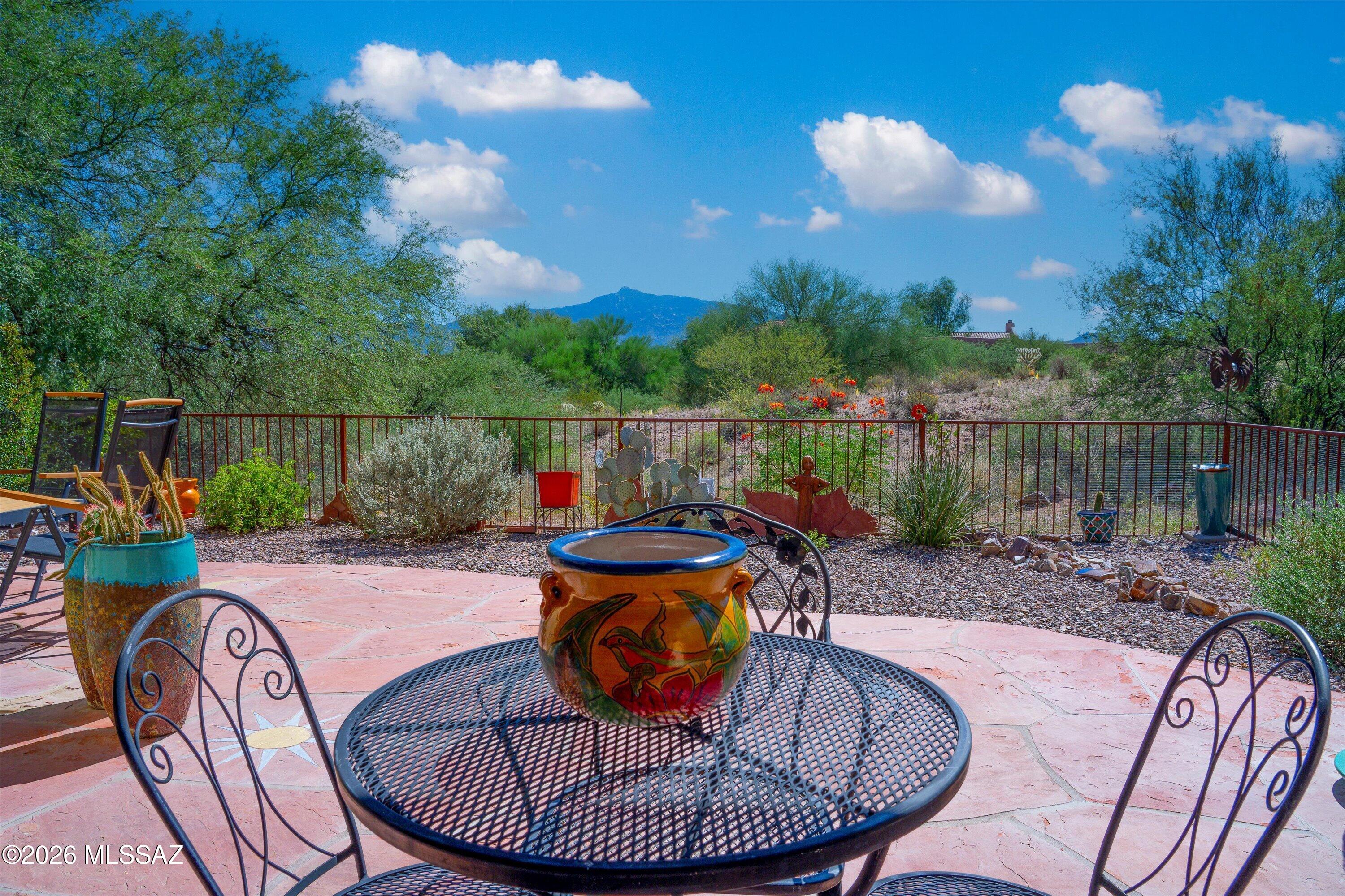 Range Price - Seller will accept or counter offers between $349,900 - $359,900. Welcome to this special townhome in the 55+ comm of Academy Village, offering Masonry const, 2 bedrooms plus a versatile den with a built-in wall unit & Murphy bed--ideal for a home office or flexible guest space. Bright & open living areas feature a dining area bay window, custom light fixture, & stunning Rincon Mountain views from the great room, primary suite, & private patio. Enjoy peaceful outdoor living with flagstone pavers & scenic views. The spacious primary bedroom includes patio access & a walk-in closet. Updates include HVAC (2024), water heater (2025), & roof recoated (2026), windows & sliders within the past five years. Private courtyard & wrought iron security door complete this exceptional home.