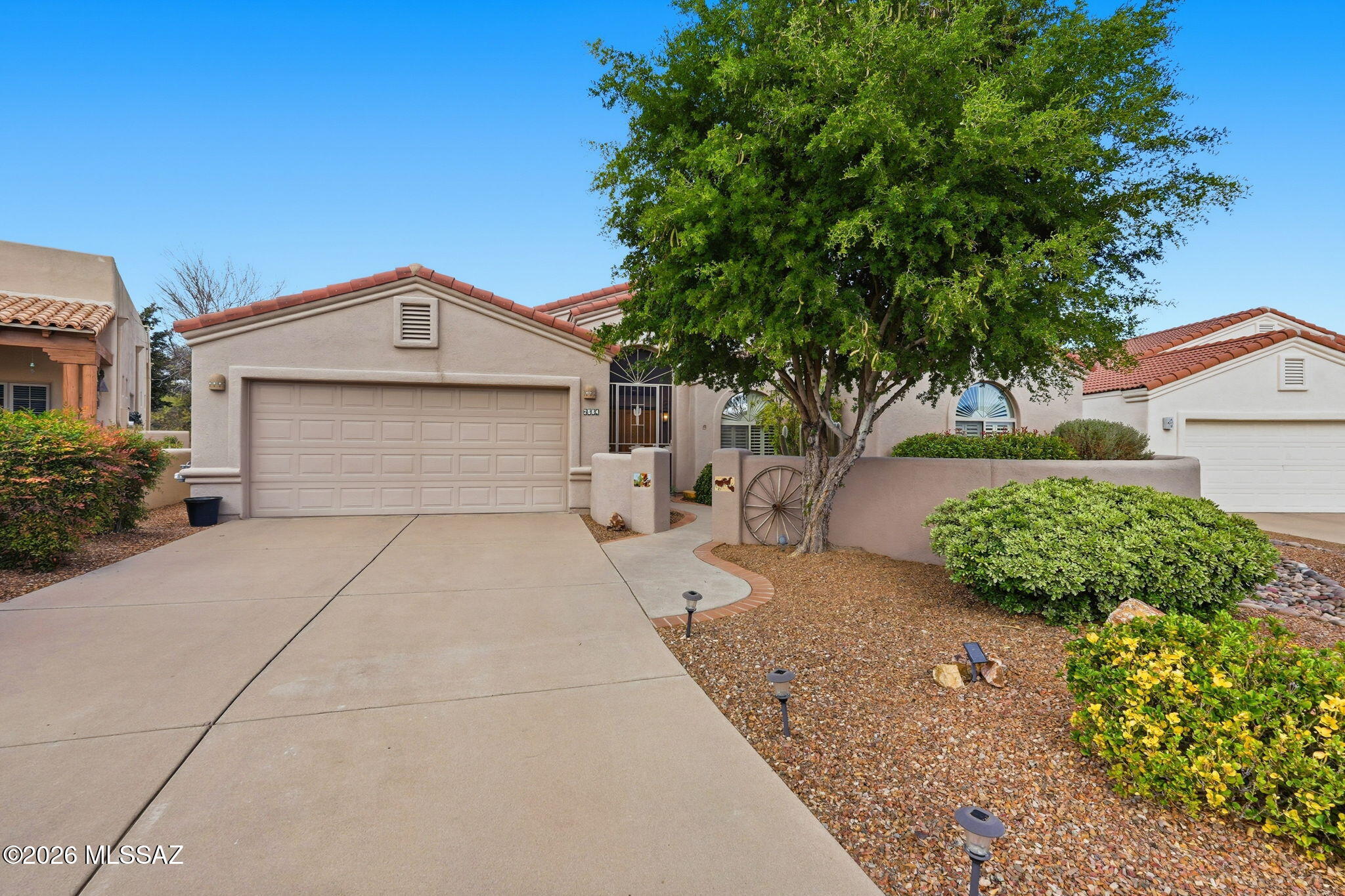 This beautifully furnished home is located in the gated Links at Santa Rita Springs community, bordering Torres Blancas Golf Course and offering the perfect blend of comfort, convenience, and the active Green Valley lifestyle. Just minutes from shopping, grocery stores, and Green Valley Recreation centers, you'll spend less time running errands and more time enjoying everything the community has to offer.

A stately saguaro cactus greets you in the front yard, while the private front courtyard with flagstone flooring provides a peaceful place to relax and take in stunning views of the Santa Rita Mountains, including Mount Wrightson and Mount Hopkins. The home also features a newly installed roof (January 2026)--the previous roof was completely removed and replaced, providing years of wor free protection. Double wood doors open to a light-filled great room with soaring ceilings and expansive windows, creating an airy atmosphere that highlights the beautiful tile flooring. The dining area is perfect for everyday meals or entertaining, while the kitchen offers abundant cabinetry, generous counter space, an island for casual dining, and modern appliances. Just off the kitchen, a versatile bonus room can serve as a hobby room, office, or cozy reading space, and the laundry room includes both gas and electric dryer hookups.

The private bedroom wing features a spacious primary suite with a charming bay window seat, ideal for enjoying quiet mornings. The ensuite bath includes dual vanities, a walk-in shower, and a walk-in closet with an organizational system. The comfortable guest bedroom offers extra storage above the closet, and the guest bath features a tub/shower combination.

Step outside through the primary suite or kitchen to a private backyard retreat featuring a covered patio with high ceilings and an expansive flagstone seating area--perfect for outdoor dining and entertaining. Mature trees and open space create exceptional privacy, while the slump block wall with iron fencing preserves views of the 7th fairway of Torres Blancas Golf Course, offering a peaceful backdrop filled with desert beauty, birdsong, and endless blue skies.