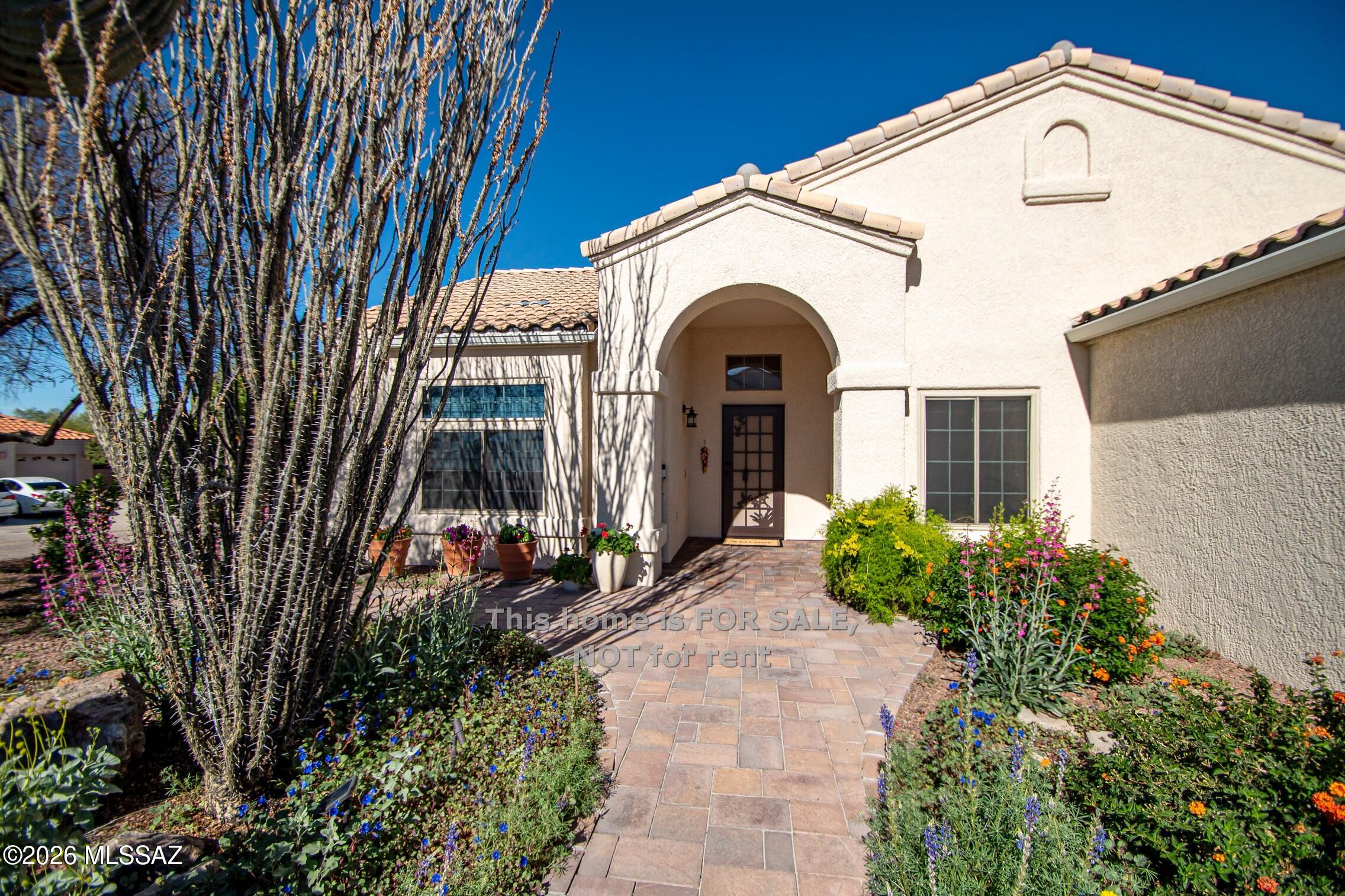 Welcome to this garden-filled retreat on a cul-de-sac lot in Northwest Tucson. Built w/durable Integra Block & steel frame construction, this 4-bedroom home features vaulted ceilings, ceramic tile & laminate vinyl plank flooring w/a flexible room ideal for an office, studio or bonus space. Enjoy an extended covered paver patio with ceiling fans and six mature citrus trees--lemon, grapefruit, orange, tangerine and mandarin--plus seasonal wildflowers in front. You'll also be blown away by the colorful crepe myrtles in the back & the Vitex Tree in the front.  This lovingly cared for home features newer HVAC(2023), Water Heater (2022) new garage door(2025), epoxy garage floors, recently painted with cleaned tile & grout. Convenient to I-10, shopping, dining and Ironwood Elemtary.