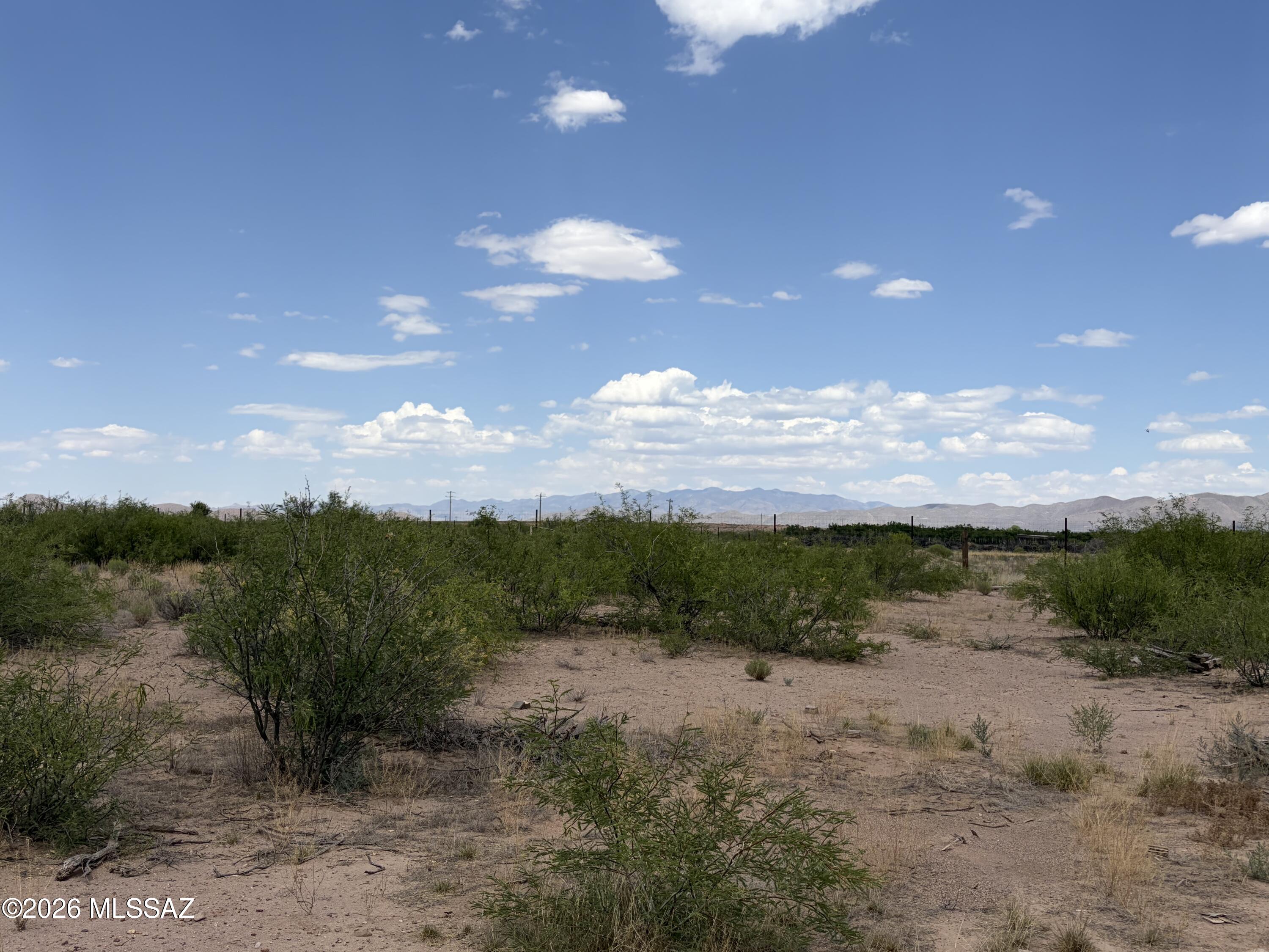 10 ACRES on Highway 191, only 1.5 miles north of Elfrida with 138' of paved highway frontage. This irregular-shaped parcel offers the majority of its usable land to the east of 10773 N Highway 191. Mostly level terrain with multiple potential building sites and several mature trees. Fencing on three sides provides privacy and definition.
Previously had a manufactured home (now removed). Private well on-site (not viable). Septic system unknown--if present, location is unconfirmed. Power is available on the lot. Priced to sell--excellent opportunity for your custom build with easy highway access in a convenient Cochise County location.