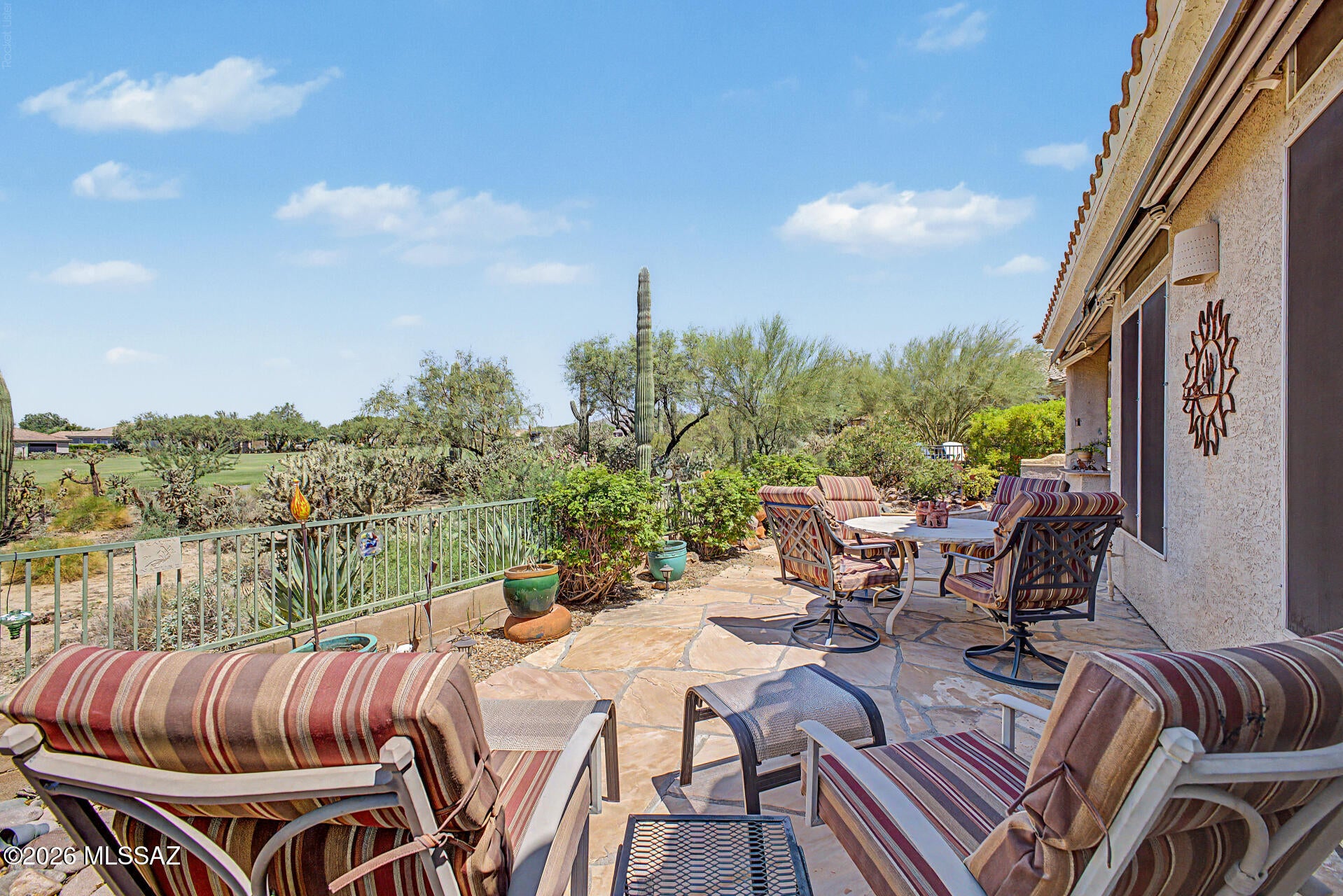 Set on the 6th fairway, this Extended Medford offers 2,162 sq. ft. with 2 bedrooms (extended 2nd bdrm), a den/office, 2 baths, and no carpet throughout. A gated front courtyard frames Catalina views, while the backyard delivers mountain and fairway vistas with a built-in BBQ, built-in bar, and two awnings. Inside, the eat-in kitchen with breakfast bar, under-counter lighting, granite counters, and pantry flows to the family room with fireplace and slider to the back patio. The dining area and living room round out the main living space. The primary suite opens via sliders to a patio and features an extended walk-in shower and dual closets. An extended utility room, newer roof, and an extended 2-car garage with workbench, storage, utility sink, and golf cart parking complete the home. Residents enjoy an award winning golf course,  remodeled clubhouse with many social and activity rooms resort-style pool and spa, fitness center, tennis and pickleball courts,  bar and restaurant plus  dozens of clubs and social activities all within a man- gated 55+ community backed  by many hiking  and biking trails. Down the Road from the Ritz Carlton, Dove Mountain.