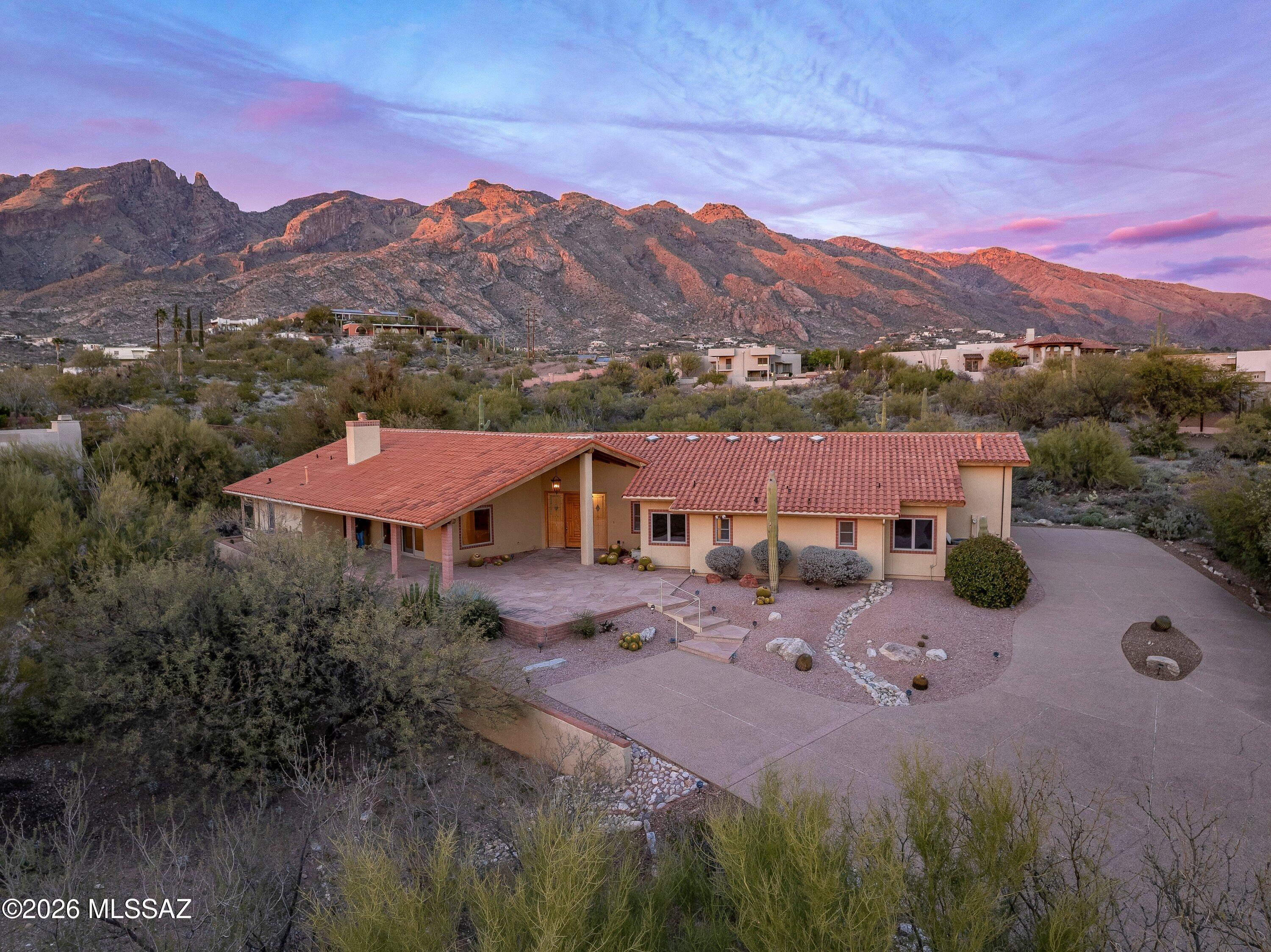 Custom home set on a private .8-acre lot with expansive mountain and desert views. Offering 3,211 sq.ft. this residence features 3 bedrooms with in suite baths and walk-in closets Plus Office and 4 baths, generous room sizes, and high ceilings throughout. The home offers a open layout with a large great room and fireplace, a spacious kitchen with gas cooktop double ovens, and a 48'' built-in refrigerator. The property has been well cared for and includes Anderson windows, surround sound, 
security system, water softener, Large bedrooms provide comfortable living, while the covered flagstone patio and spa create an inviting outdoor space to enjoy the beautiful mountain views and peaceful setting. Located in the prestigious, gated La Paloma community, the home offers privacy & mountain view