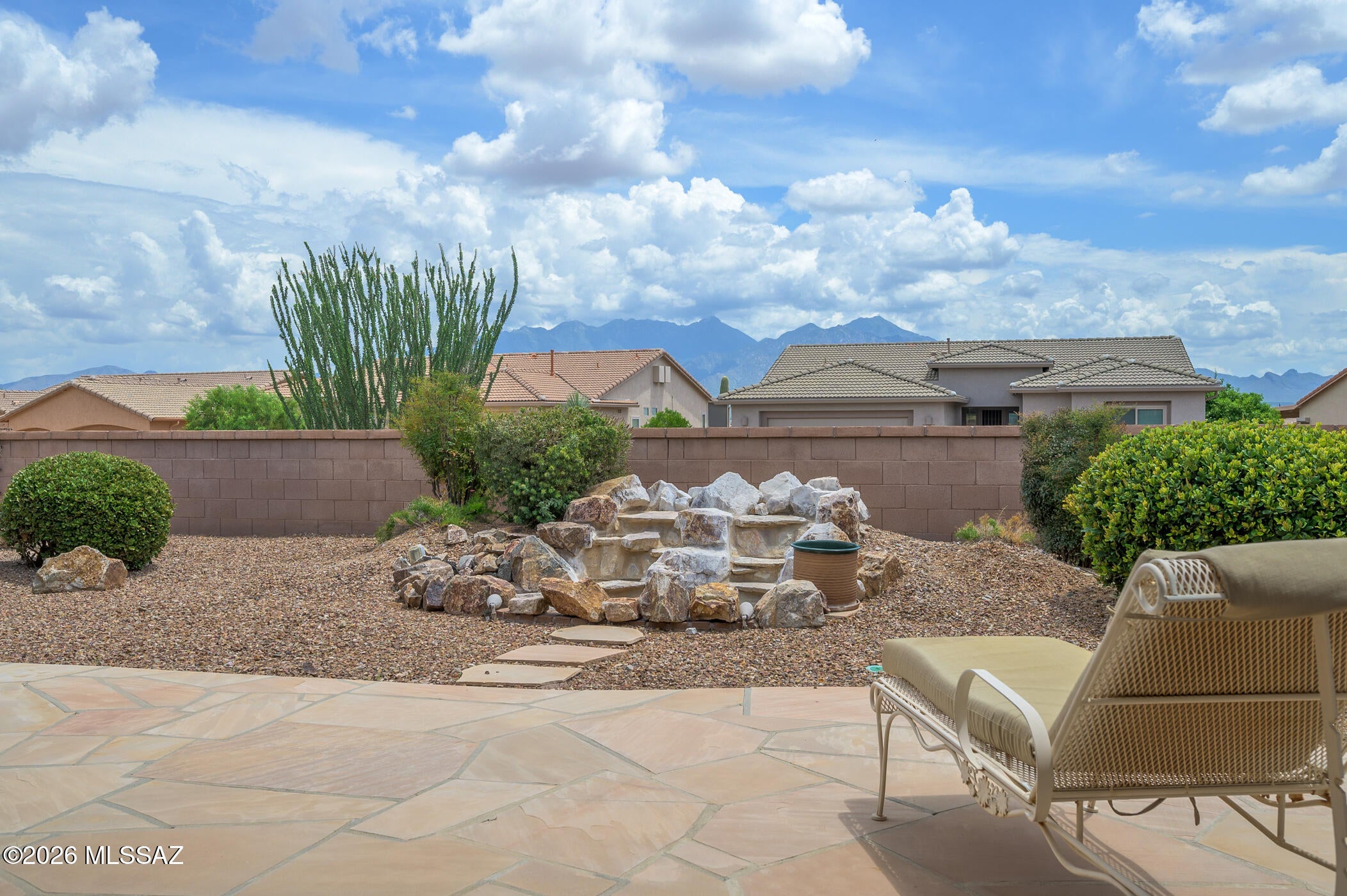 Elegant 2 bed, 2 bath, 3 car garage home in gated Canoa Northwest w/inviting curb appeal, a delightful flagstone back patio, and mountain views. Inside, the open concept dining & great room offer warm versatility, complemented by an additional living space w/ generous wall space for artwork- ideal for formal dining & living or hobbies, gatherings or office use. The open concept kitchen offers abundant cabinetry, Corian countertops, a gas range, large island with breakfast bar & flexible nook for casual dining. The private primary suite features patio access, walk in shower, soaking tub, dual sinks, & spacious closet. A versatile guest bedroom and updated bath add comfort. A large laundry room with sink and storage adds convenience. Relax outside w/ mountain view and enjoy 55+ Green Valley
