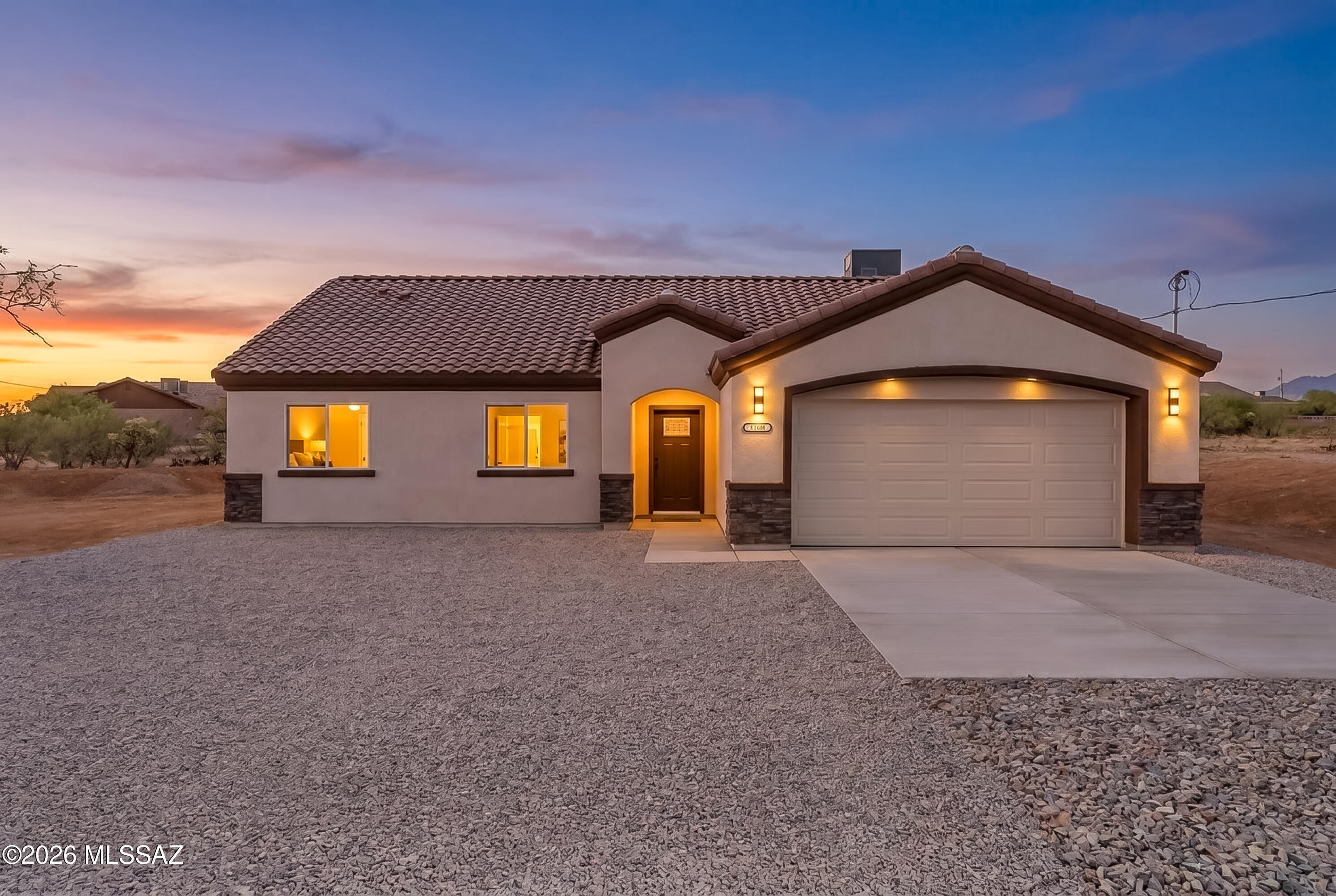 Welcome to this stunning new construction home situated on a spacious 0.41-corner lot, offering breathtaking mountain vistas and modern comfort. Designed with an open-concept layout, the expansive gathering space features vaulted ceilings that create an inviting atmosphere. The thoughtfully designed kitchen showcases custom cabinetry, upgraded finishes, and quality craftsmanship throughout. A durable tile roof adds timeless curb appeal, while the home's elevated features and attention to detail make it stand out from the rest. Enjoy the beauty of Rio Rico from your own backyard, where sweeping mountain views provide the perfect backdrop for relaxation and outdoor living. This exceptional new build seamlessly blends style, functionality, and scenic surroundings into one remarkable home.