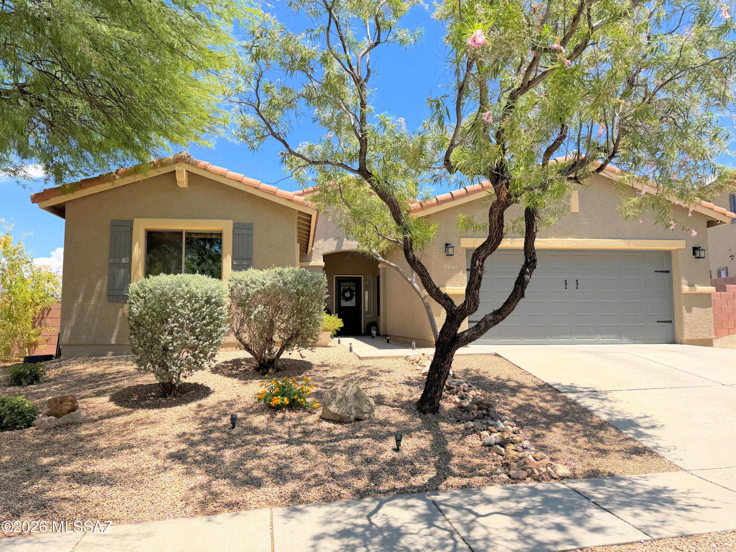 Seller will consider offers $419,500-$429,500. Wake up to breathtaking Santa Rita Mountain views from this beautifully maintained home in desirable Sycamore Canyon! This move-in-ready great room floor plan features 3 bedrooms, 2 baths, plus a private double-door office/den. The updated kitchen offers granite countertops, KitchenAid stainless appliances, and opens to spacious living and dining areas. Relax in the fully landscaped backyard with paver patio, inviting seating areas, and open desert and mountain views. Additional highlights include a remodeled laundry room, under-sink water filtration, Milgard windows, Trane HVAC, tandem 3-car garage, and award-winning Vail Schools.