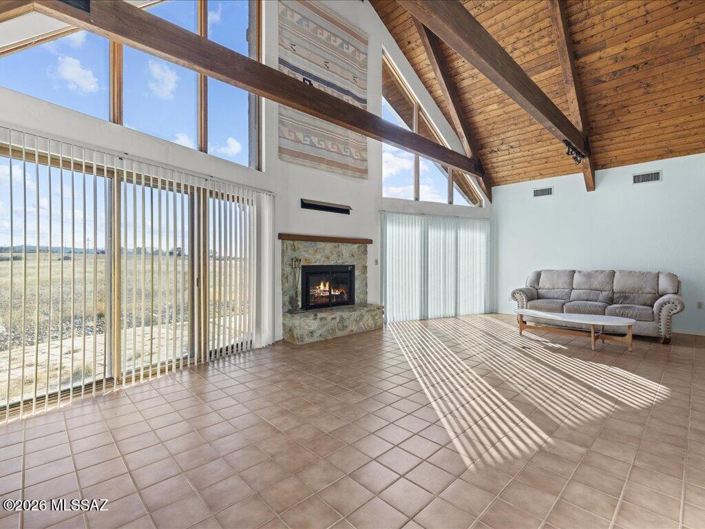 Custom home built on 10+ acres with old oak trees and native grass. The home has new exterior paint, new carpet, new tile in bathroom, and new stove in kitchen. Open wood truss ceiling and large windows in the great room with a big cozy fireplace,  bedroom/office downstairs is large enough to make into a third bedroom. Loft and primary bedroom upstairs with en-suite, and walk-in closet w/cedar. Two car garage has utility area and laundry. Outdoor block structure with roof could be for animals, or storage. Amazing views of the Santa Rita Mountains, Great location, close to town center and restaurants. National Forest just down the road for riding, and hiking. Easy commute to Tucson, Nogales, & Sierra Vista. +++Extra land  adjacent to this property can be bought, 8.95 acres for $175,000