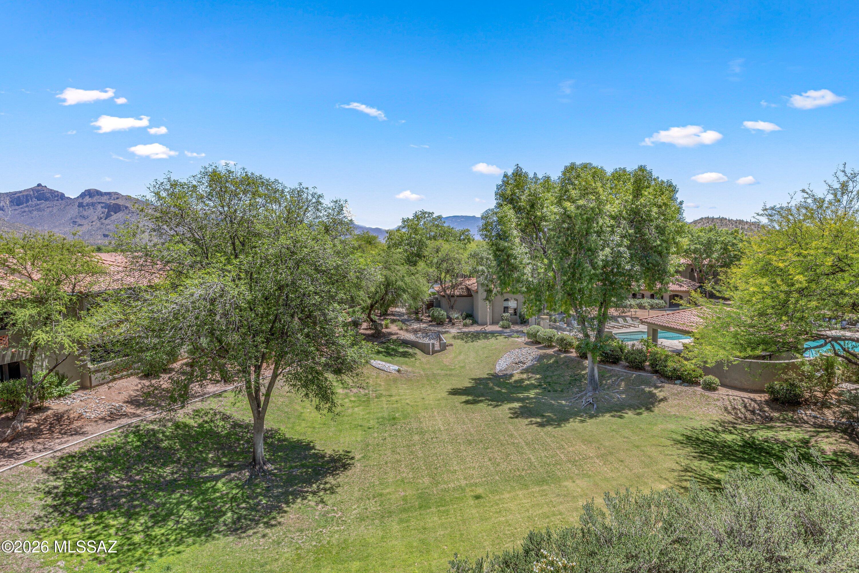 GATED COMMUNITY IN THE FOOTHILLS NEAR VENTANA CANYON & SABINO CANYON. PRIVATE 3-BEDROOM UNIT WITH STUNNING MOUNTAIN VIEWS FROM THE GREAT RM, PRIMARY BR, SECOND BR & KITCHEN! This second-floor condo offers a perfect balance of comfort and style. The interior has been freshly painted and has wood and tile flooring throughout.  The kitchen features stainless steel appliances, updated cabinetry & black hardware for a polished look. The split-bedroom layout is designed for privacy, with three spacious bedrooms, each with its own walk-in closet and a ceiling fan with light. The primary suite has an updated bathroom & balcony access with a MOUNTAIN VIEW!  Modern light fixtures throughout. The hall bath, shower, and sink were professionally resurfaced. Washer, dryer, and refrigerator are included! Community amenities include a gated entrance, a workout room, a clubhouse, two pools, two spas, a volleyball area, a playground, multiple BBQ grills, and ramadas for picnicking. Be close to the world-class Ventana Canyon Resort and all the restaurants and conveniences located at Kolb and Sunrise. This is a must see Foothills condo if you are looking for low-maintenance living.
