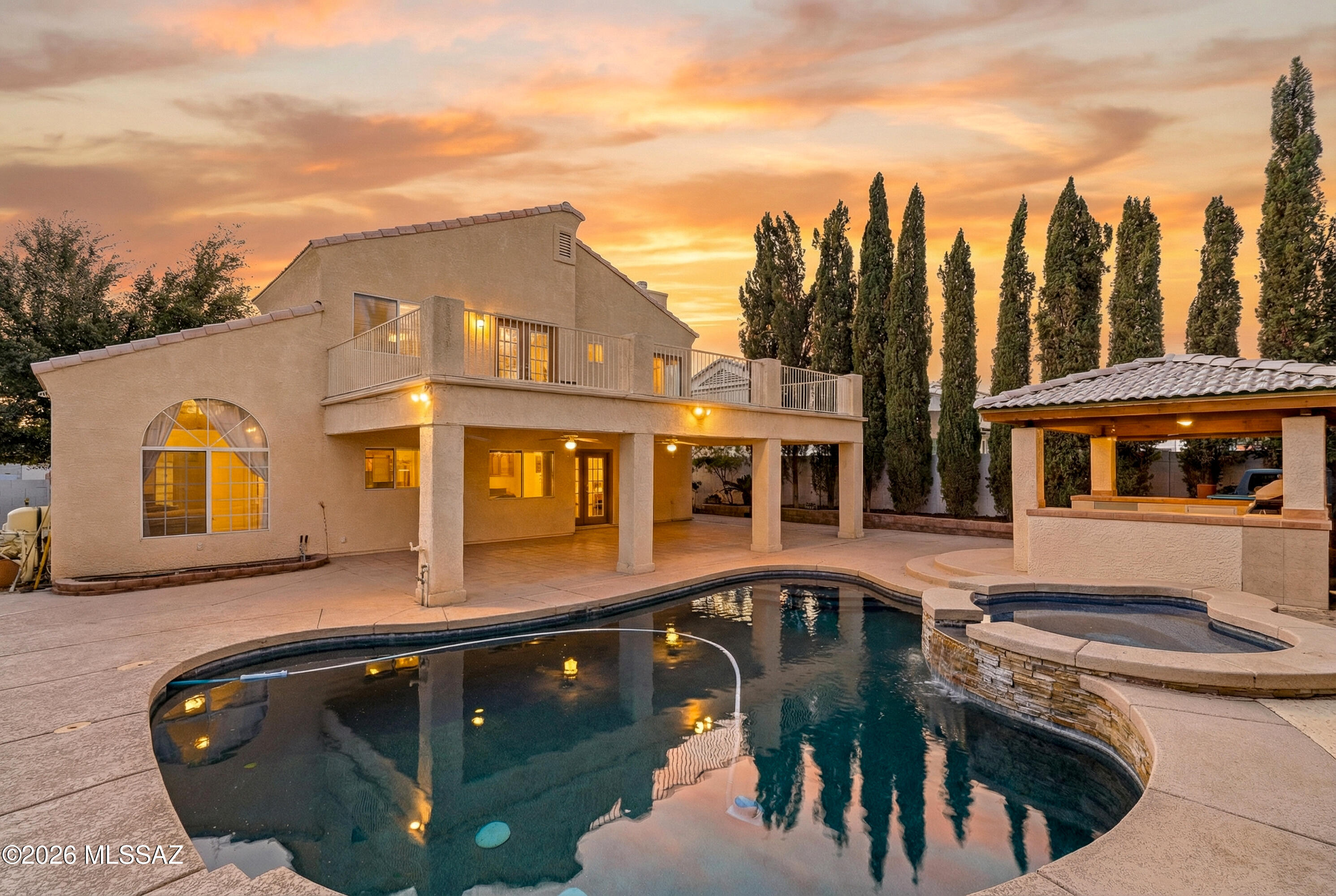 Welcome to this beautiful northwest corner-lot home in a newer subdivision with no HOA. The master suite features French doors, dual sinks, a jacuzzi tub, separate shower, and private balcony with serene mountain views. The gourmet kitchen is a chef's delight with granite counters, cherry cabinets, stainless appliances, large island enhanced by a custom mesquite extension. A cozy fireplace warms the family room, complemented by formal living and dining spaces. Step outside through French doors to an oversized yard designed for entertaining, with pool, jacuzzi, covered patio, and ramada—ideal for enjoying Arizona's indoor-outdoor lifestyle. 3rd garage currently being used as a 5th bedroom but can easily be restored to a garage.