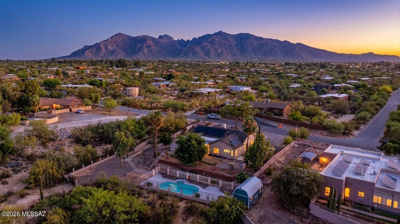 🌵 Desert Charm Meets Modern Comfort in North Tucson 🌄 Priced below recent $615,000 appraisal, rare opportunity to own your own private Sonoran paradise! Nestled in a quiet pocket of desirable North Tucson, 2,157 SqFt 4 bed/2 full bath, single story, no stairs/no steps 1996 custom built modern contemporary home with heated salt water pool and spa, large 576 SqFt attached 2 car heated/cooled finished garage with additional storage cabinets, separate metal carport, seller financed residential solar photovoltaic system plus additional Tesla storage batteries will be paid off by seller, convey to new owners free and clear at close of escrow ($50K value). Premium elevated 1.5 acre unsubdivided fenced CR1 lot, this unsubdivided property offers the freedom you've been craving: no HOA, no CC&Rs (Covenants, Conditions, and Restrictions), RV parking with full RV hookup (including 240V and sewer connection), providing plenty of space to build, store your RV, trailers, and toys. Featuring E/W orientation providing epic unobstructed daily sunsets, omnipresent Catalina mountain views, architectural shingle roof, sewer clean outs and concrete driveway.
Inside buyers will appreciate energy efficient double pane windows throughout, plantation shutters, window blinds, Pex and copper plumbing (no polybutylene plumbing), soaring painted textured ceilings (no popcorn), recessed lighting, hard-surface flooring throughout with tile and travertine stone finishes (no carpet), zoned gas HVAC (new 2021) with humidity control, mini-split ductless in garage for an cooled/heated work space or convert to home gym, digital thermostat, ceiling fans, internal laundry room w/gas hook up, recent gas water heater (2023), custom wallpaper in guest bedrooms,  spacious family room/formal dining area, remodeled entertainer's kitchen with gorgeous full slab granite countertops, matching full slab granite island with bar seating, recent gas stove (new 2021), dual ovens including convection oven, energy star dishwasher (2023), closet pantry, stainless steel appliance package, slim built-in microwave, ample kitchen cabinets, double metal sink under garden window, adjacent to living room with wood burning fireplace w/gas and sliders out to covered patio. Primary bedroom retreat offering ensuite full bathroom w/ updated tiled walk-in glass shower, dual sink cultured marble vanity, bidet, dual closets including massive walk-in.
Enjoy tranquil Tucson nights and epic sunsets from private West facing tiered backyard with 924 SqFt extended covered patio, enjoy year round heated salt water pool and spa, built-in barbecue grill and tiled bar w/bar seating, flagstone, metal gutters, brick pavers, flower gardens, custom fire pit, metal shed, view fencing, block privacy walls and gated for toys. Whether you're entertaining, relaxing, or stargazing under Tucson's famous skies this backyard is sure to please. Priced to sell, call to make your appointment to view this move in ready home today!