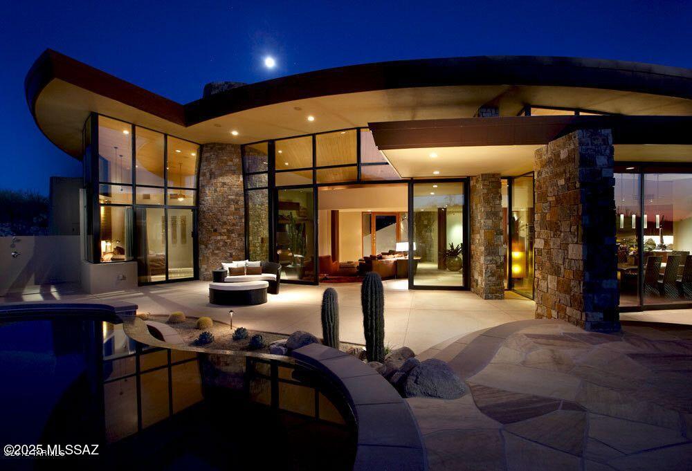 Nestled on a secluded 3-acre lot in the prestigious Pima Canyon Estates, this extraordinary estate, designed by renowned architect Kevin Howard and a proud recipient of the ASID 1st Place Award, offers an unparalleled blend of contemporary elegance and Southwestern charm. Just moments from La Encantada shopping, scenic hiking trails, biking paths, and top-tier golf courses, this masterpiece is built for those who appreciate both luxury and adventure.
This home's open-concept layout is a true work of art, featuring stunning Cardinal windows that frame breathtaking views of the Santa Catalina Mountains. Inside, you'll find the finest craftsmanship, with sleek, contemporary cabinetry, exotic honed granite countertops, and a suite of gourmet appliances. Desert Sun Sandstone flooring flows ,& huge picture windows to take in the Santa Catalina Views. The home consists of the Main Residence w/ an attached guest house & roof top patio. The opulent Master Bd Suite has access to the outdoors & a separate Jacuzzi tub, Rain, Body & Steam Shower for ultimate relaxation. Den/Office completes the master wing of the home