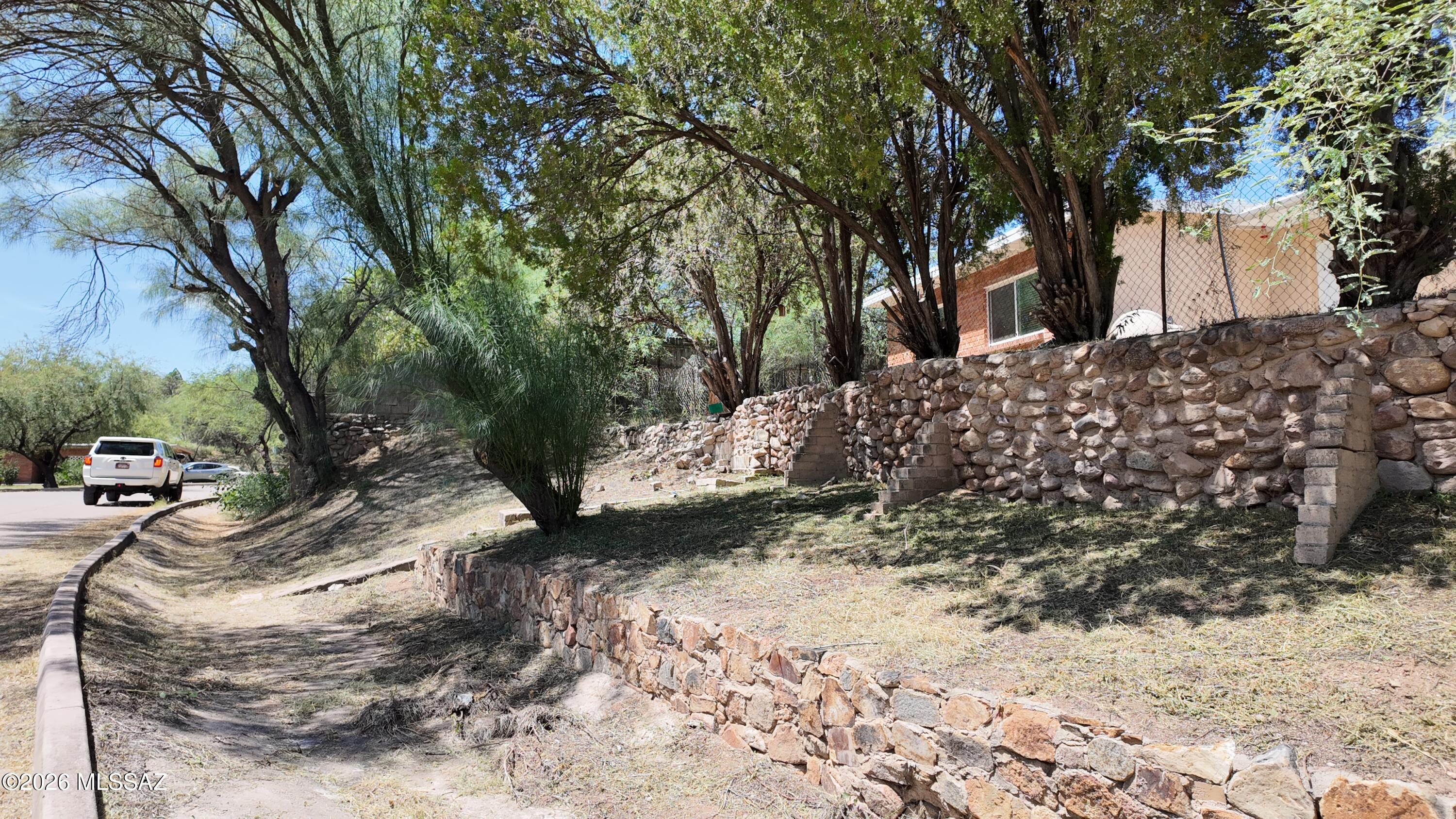 Welcome to this spacious 1456 sq. ft. home situated on .32 acres in the quiet, established Sleepy Hollow/Oakridge Subdivision on the outskirts of Nogales. This inviting property features 3 bedrooms, 2 bathrooms, plus an add'l room that could be used as a 4th bedroom, home office, den or hobby room.  Recent improvements include a fairly new roof,  A/C, ceramic tile flooring and mature landscaping.  The adjacent .54 acre parcel is also available for purchase under separate contract.