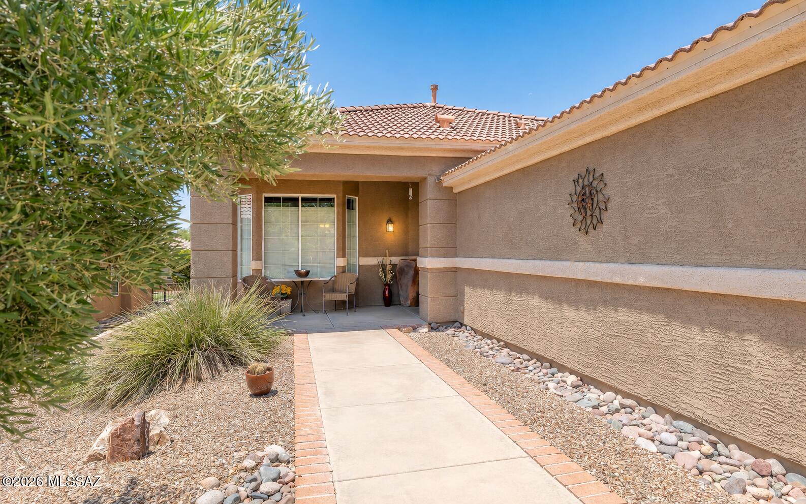 A highly desirable Durango model w/bay windows - in excellent condition. Beautiful high end engineered hardwood floors, newer HVAC system - very clean and crisp home.  Open great room concept floor plan.  Inviting back patio/porch w/expansive electronic awning - and yes, it has some Marana city lights to the South and some distant mountain peaks between homes. Front porch also makes for a very nice relaxation area that has lovely mountain views. Kitchen has granite countertops and lowered breakfast island bar - all appliances including side by side refrigerator conveys.  Laundry in garage alcove so bonus/flex room is a highly desired addition-currently set up as an office. This is a very peaceful home and a very well kept home.  Close to clubhouse. Remaining furniture in home is available: Furniture that is available at a very fair price:
Office/Den Furniture - (desk, credenza, file cabinet)
Foyer Table and Lamp (which is foyer closet).
Great Room Furniture -including entertainment center, TV, end tables, lamps, couch & chair.
Guest Bedroom furniture -includes bed, lamps & 2 nightstands.
Kitchen Bar Stools
Dining Room Table & 6 chairs
Bistro set on front porch.