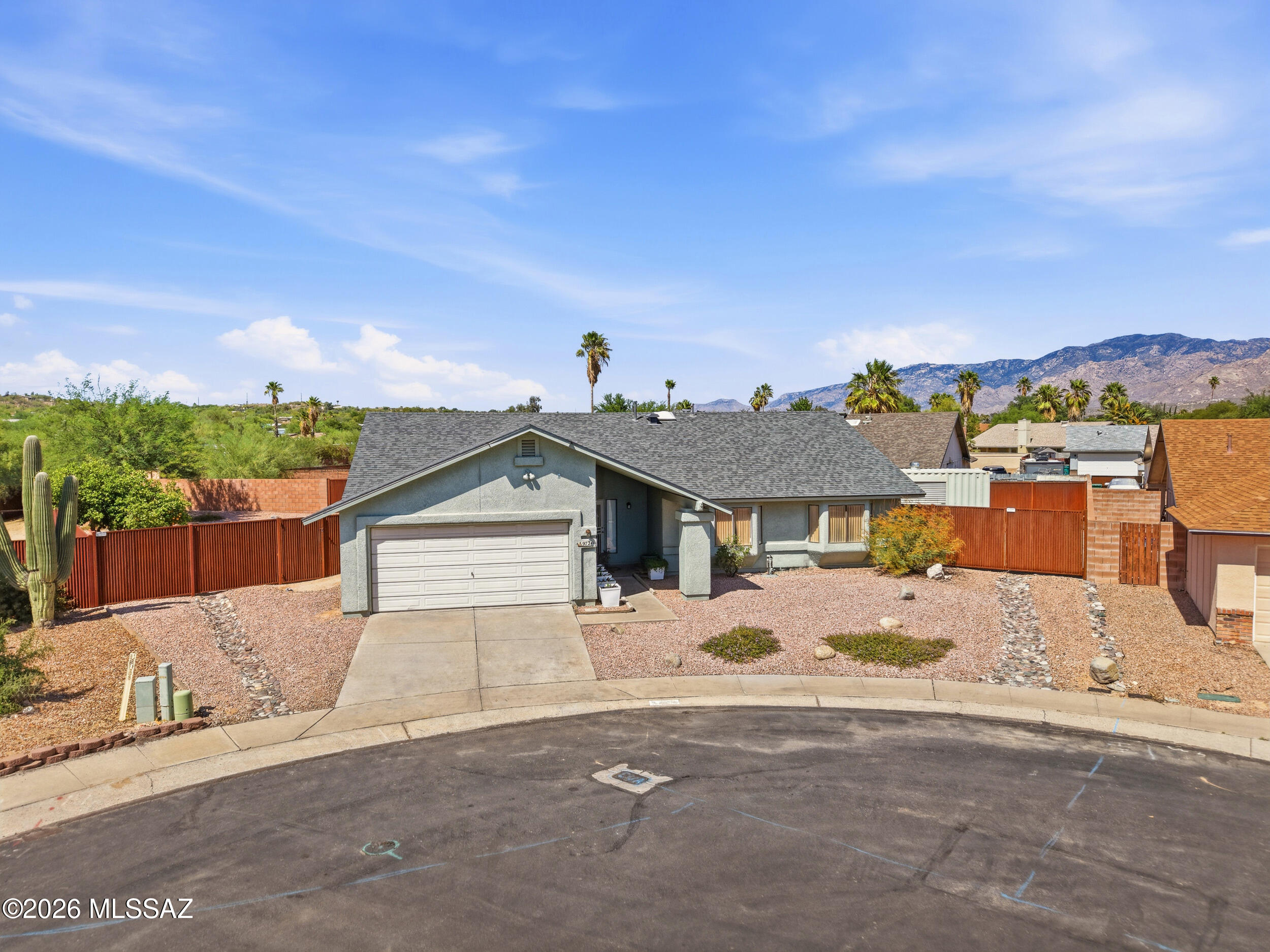 Well-maintained Oro Valley home situated on a spacious .24-acre cul-de-sac lot with no HOA, RV gate access, and mountain views. This move-in ready property features vaulted ceilings, abundant natural light, and an open-concept layout that creates a bright and inviting feel throughout the main living areas. The kitchen flows seamlessly into the living and dining spaces, offering functionality for both everyday living and entertaining.

Step outside to an oversized backyard with endless potential for a pool, outdoor kitchen, garden, or custom entertaining space. The side yard offers additional flexibility with a 20-foot storage container and room for RV parking behind the double gate.

Major improvements include a new roof installed in 2024, upgraded 200-amp electrical panel, irrigation updates completed in 2025, and a serviced 5-ton gas split HVAC system. Additional features include an evaporative cooler setup.

Conveniently located near shopping, dining, parks, schools, and Oro Valley amenities, this property offers the rare combination of space, flexibility, and no HOA living in one of Tucson's most desirable areas.