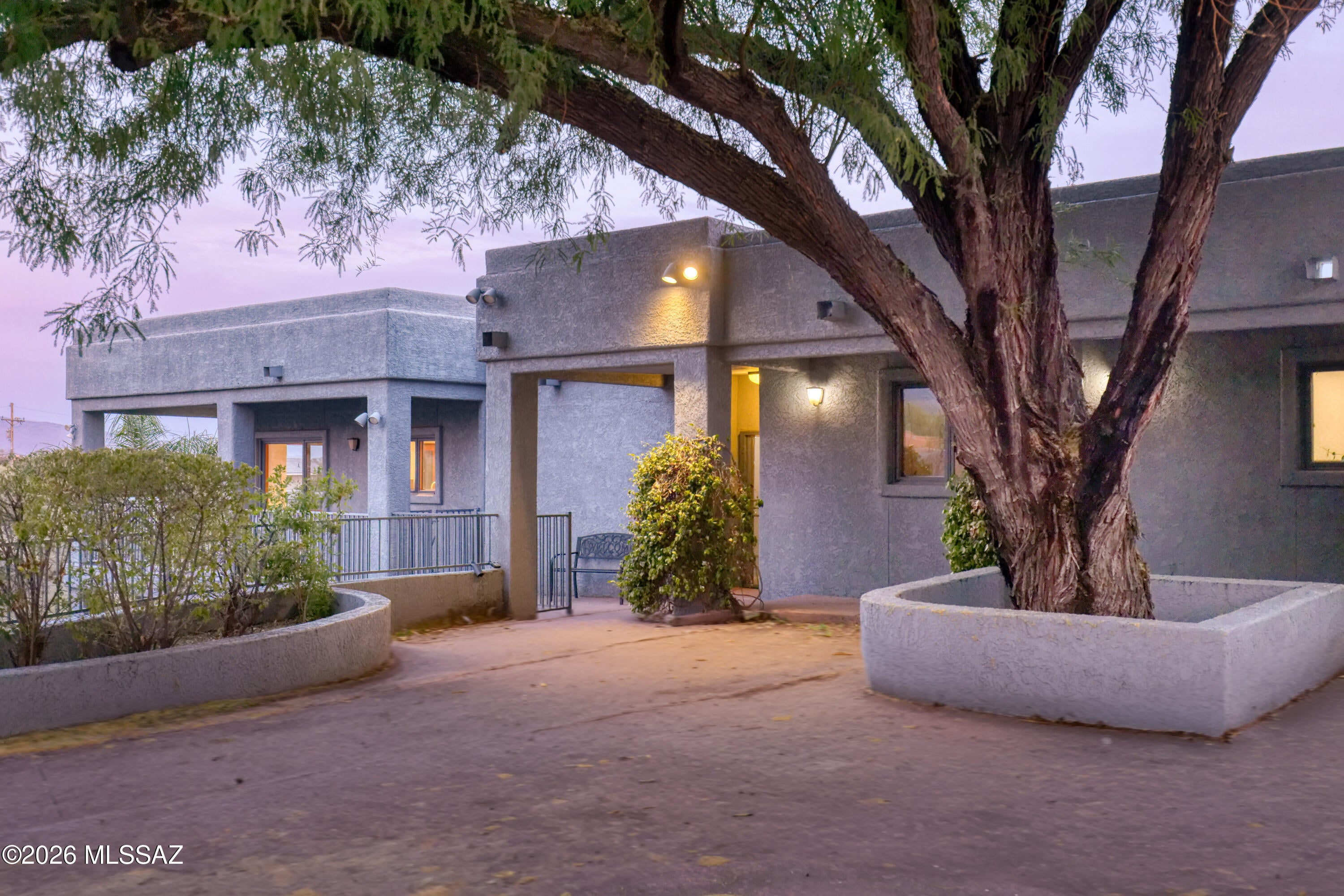 Set on just over an acre in the Catalina Foothills, 5036 N Calle Bosque is a 3,500-square-foot home with something that's hard to find: space, privacy, a pool, and incredible views of both the Catalina Mountains and Tucson's city lights.

The two-story home has 4 bedrooms and 3 bathrooms, with two primary suites--one upstairs and a second ensuite on the lower level. That second suite gives the home plenty of flexibility for guests, extended family, a roommate, or anyone who wants their own space.

The main living areas take full advantage of the views, with large windows bringing the mountains and city into the home. The kitchen has a generous island and opens to the surrounding living spaces, making it easy to cook, gather, and entertain without being separated from everyone else.