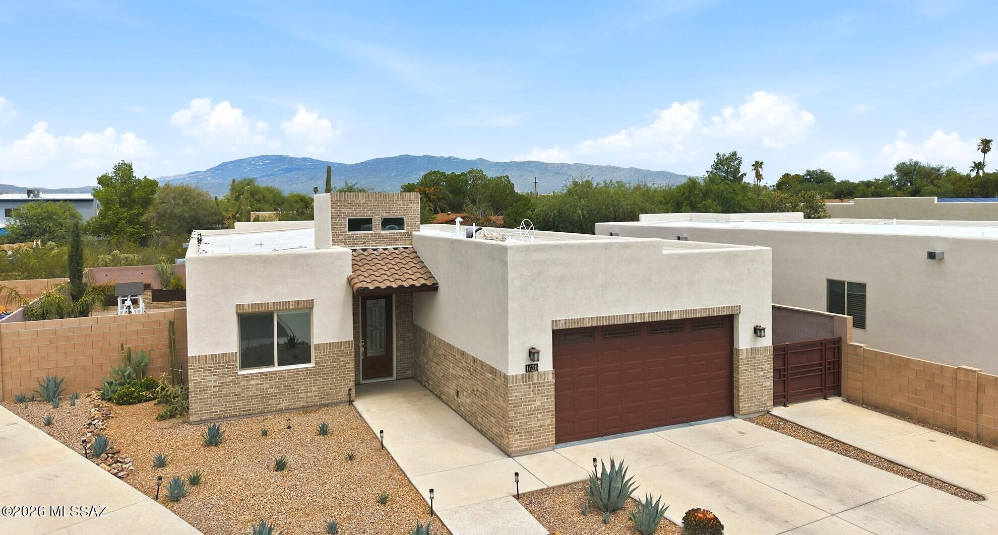 Exceptionally well-done home is a 2211 SF one-story, open floorplan with 4 full BR/3 BA split BR plan. New-home style, amenities and finish. Unbeatable NE Tucson location in an enclave of 12 Builder-homes 2020. Premium features throughout: high ceilings, vaulted foyer, recessed lighting, ceramic plank flooring and wood-laminate flooring, dark cabinetry and marble countertops. Gourmet kitchen, full-length island with gas range and hood, stainless appliance suite. Covered, tiled patio and private wrap-around yard with pavers, custom planters, BBQ, play area. Custom finish-details throughout. 
Close-in town NE established area of schools, hospitals, shopping, restaurants, parks, Udall recreation, Sabino Canyon, hiking, golf, employers. Quick Move-in! Please present all offers. Must see!