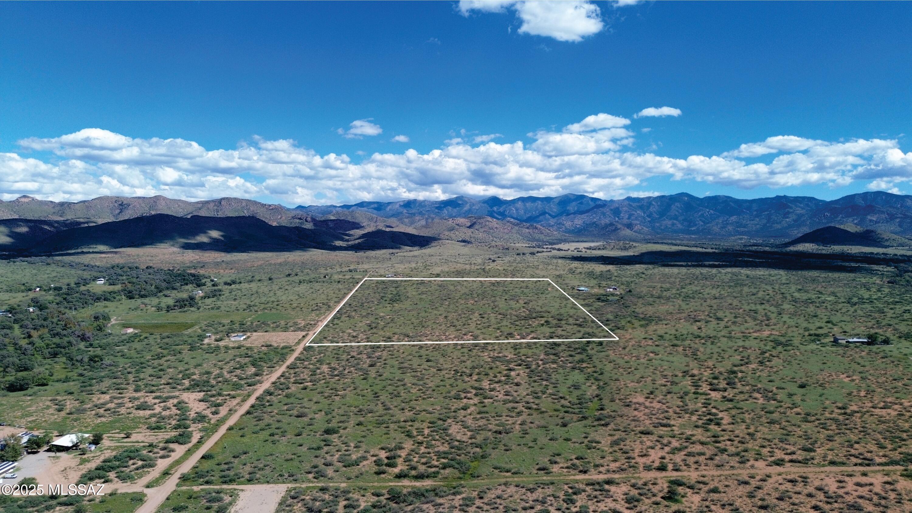 Set at the base of the striking Chiricahua Mountains in southeast Arizona, this 65-acre property offers privacy and natural beauty. The semi-flat terrain provides accessibility and openness, making it ideal for a secluded homestead or peaceful retreat. Surrounded by rugged desert flora and framed by towering peaks, the land captures the essence of untamed wilderness while offering a quiet escape from the outside world. With vast, dark skies overhead, it is a dream for stargazers, offering breathtaking views of the cosmos in an unspoiled setting. this is a  private getaway to reconnect with nature, this land is a rare opportunity to experience the serenity and raw beauty of classic Arizona living.