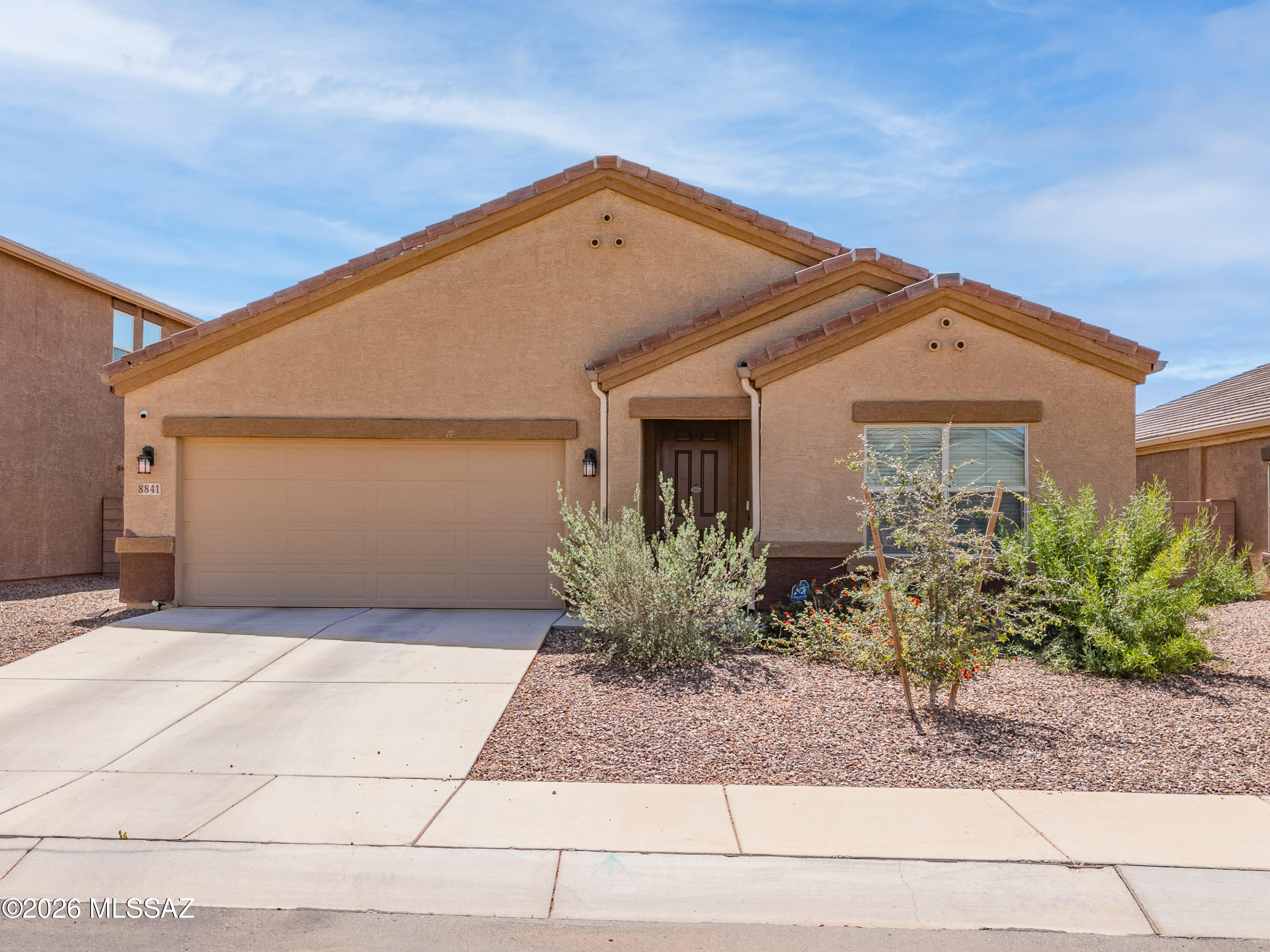 Discover this beautifully maintained, like-new home in the desirable Cholla Ridge at Saguaro Bloom community in Marana. Offering 4 bedrooms, 3 bathrooms, and 2,027 square feet, the floor plan includes a den and an Arizona Room--ideal for a home office, hobbies, or additional living space. This smart home is equipped with a full alarm system, reverse osmosis drinking water system, and a whole-home water softener for added comfort and convenience. A welcoming entry leads into a bright, open-concept Great Room and kitchen designed for both comfort and entertaining. The kitchen features granite countertops, a spacious island, stainless steel appliances, and plenty of cabinet space, all complemented by high ceilings that enhance the home's airy feel. The primary suite provides a relaxing retreat with an en suite bathroom complete with dual vanities, a walk-in shower, and a large walk-in closet. Additional bedrooms offer versatility for guests or family. This energy-efficient home includes leased solar for added savings. Step outside to enjoy the enclosed, climate-controlled patio and a generously sized backyard with mountain views, ready for your personal vision. Residents enjoy access to community amenities including a pool, spa, parks, and a community center. Conveniently located near schools, shopping, dining, and easy freeway access, this home offers the perfect blend of comfort, style, and convenience--without the wait of new construction.