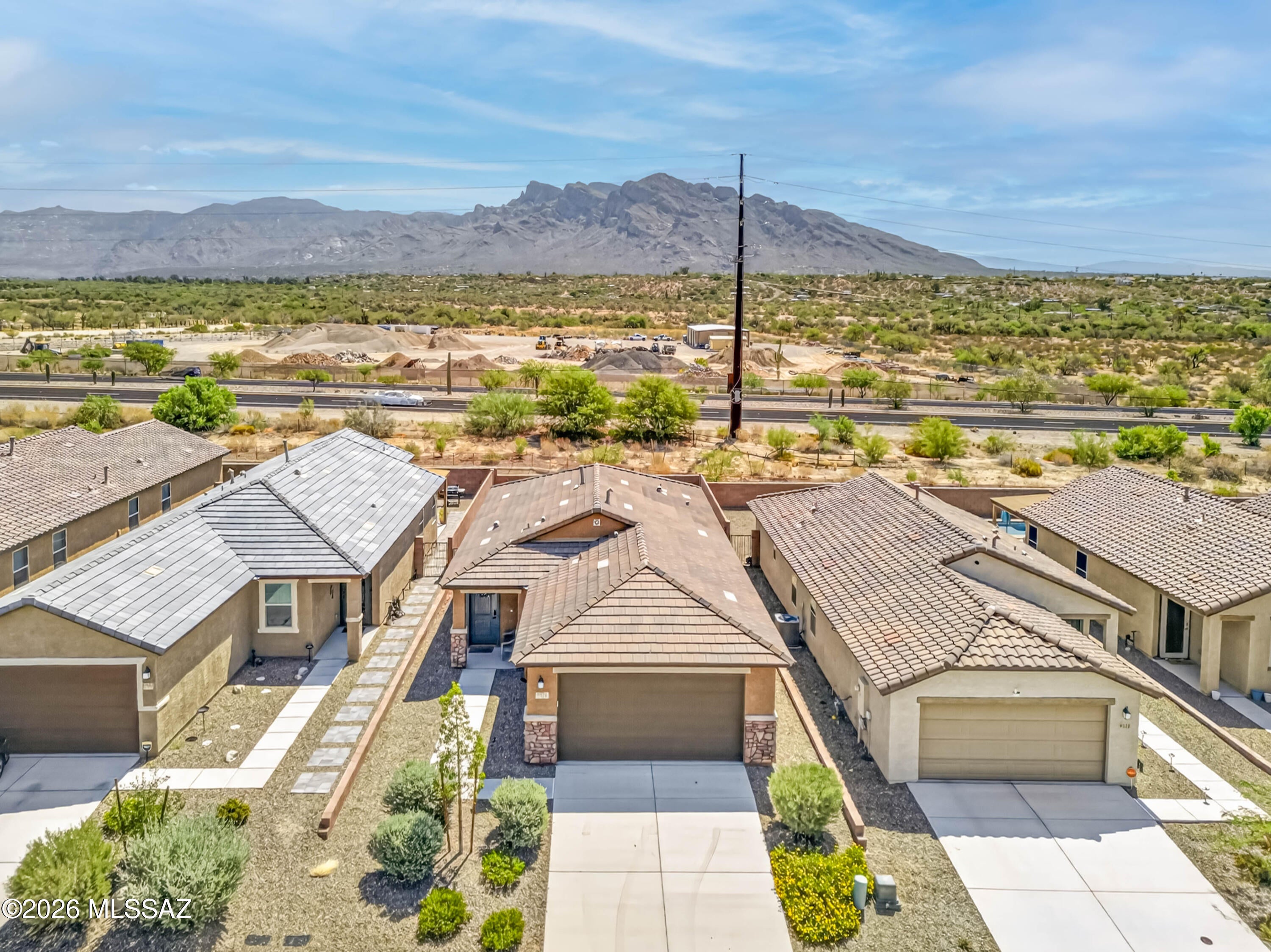 Sellers to provide up to $5,000 Seller Concessions with acceptable Offer!  VIEWS, UPGRADES & DESIRABLE LOCATION!  Wake up to beautiful Santa Catalina Mountain views in this nearly new, beautifully upgraded 3-bedroom, 2-bath home in popular Casas Adobes. Built in 2023, this 1,262-square-foot home features an open floor plan, abundant natural light, a 2-car garage, and an oversized east-facing backyard with no neighbors directly behind.  The backyard is designed for easy, comfortable outdoor living, with low-maintenance turf, desert landscaping, irrigation, a calming fountain, and a covered patio equipped with a ceiling fan, electric heater for cooler evenings, and electric shades for added privacy and sun protection. Enjoy mountain views from the east-facing windows and glass sliding doors. The upgraded kitchen features granite countertops, a large peninsula, navy tile backsplash, and Whirlpool stainless-steel appliances, including a refrigerator with ice maker and water dispenser. All appliances convey, including the Whirlpool washer and Dryer. The spacious primary suite offers beautiful mountain views, a large window, walk-in closet, and en-suite bathroom with double vanity and bidet toilet. Additional features include vinyl plank flooring throughout the main living areas, a tankless water heater, water softening system, EV charger, and overhead garage storage.  Turn-key/furnished option may be available--ask the listing agent for details.  Ideally located near the Chuck Huckleberry Walking and Cycling Loop, Catalina State Park, shopping, dining, golf, medical facilities, and easy I-10 access. Nearby destinations include Casas Adobes Plaza, Oro Valley Marketplace, La Encantada, Tucson National, Northwest Medical Center, and Oro Valley Hospital. The home is also within cycling distance of the upcoming Uptown urban resort community center. A beautiful, low-maintenance home with mountain views, an exceptional backyard, and thoughtful upgrades--ready to enjoy from day one!
