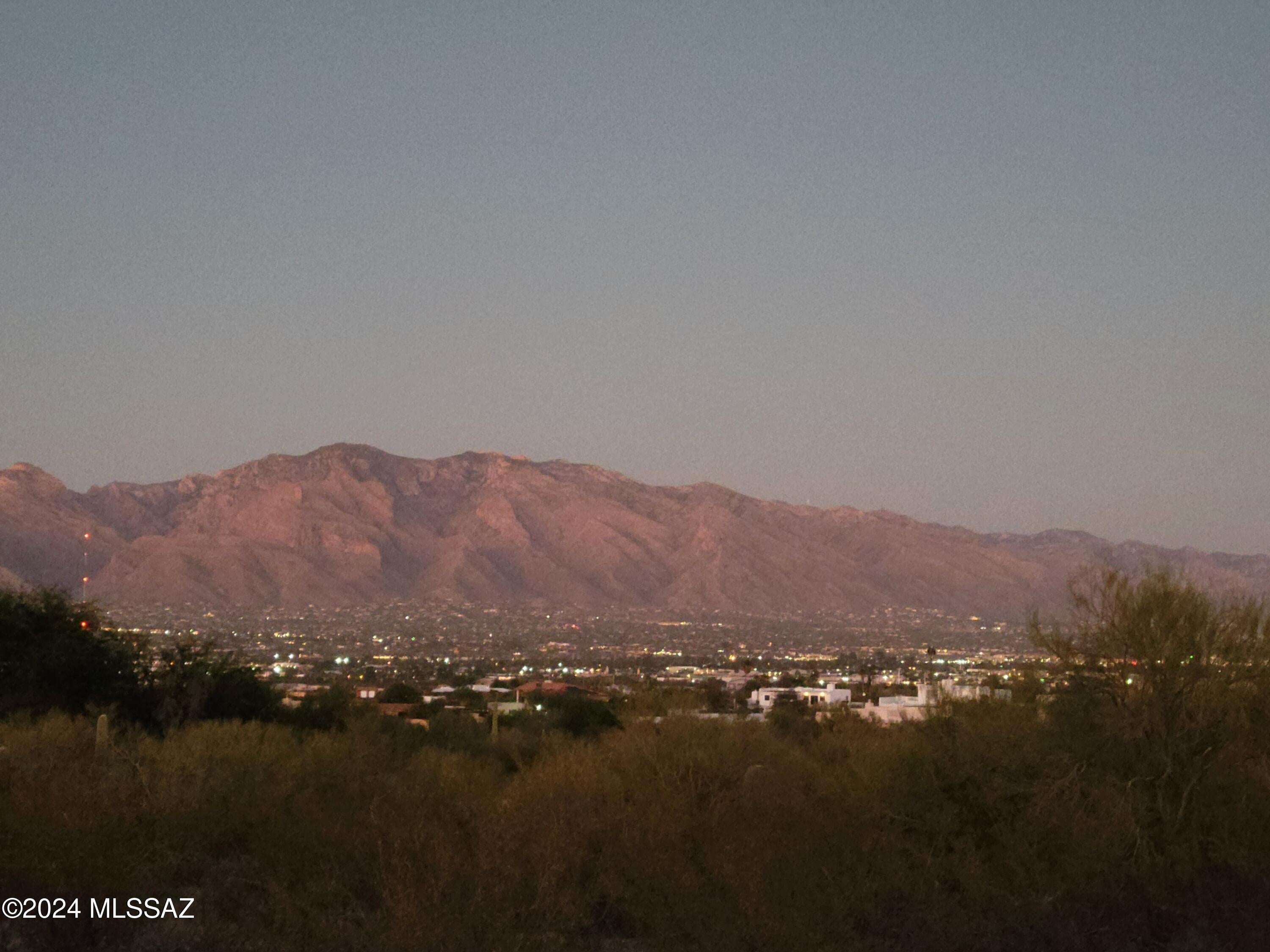 Phenomenal Panoramic Views & Owner Financing Available! Discover this exceptional 5-acre Tucson parcel with breathtaking city, mountain, sunrise and sunset views! An elevated, relatively flat building site offers privacy and tranquility, yet is close to everyday amenities, I-10, downtown Tucson, shopping and dining. Architectural house plans approved by Pima County in 2024 convey with the property, offering a head start on your dream home, or customize to suit your vision. Electricity, natural gas and city water at the property lines. Successful septic perc test, completed survey and road maintenance agreement. Near Sweetwater Preserve, Tucson Mountain Park and scenic hiking and biking trails. Enjoy the beauty of the Sonoran Desert without sacrificing convenience!