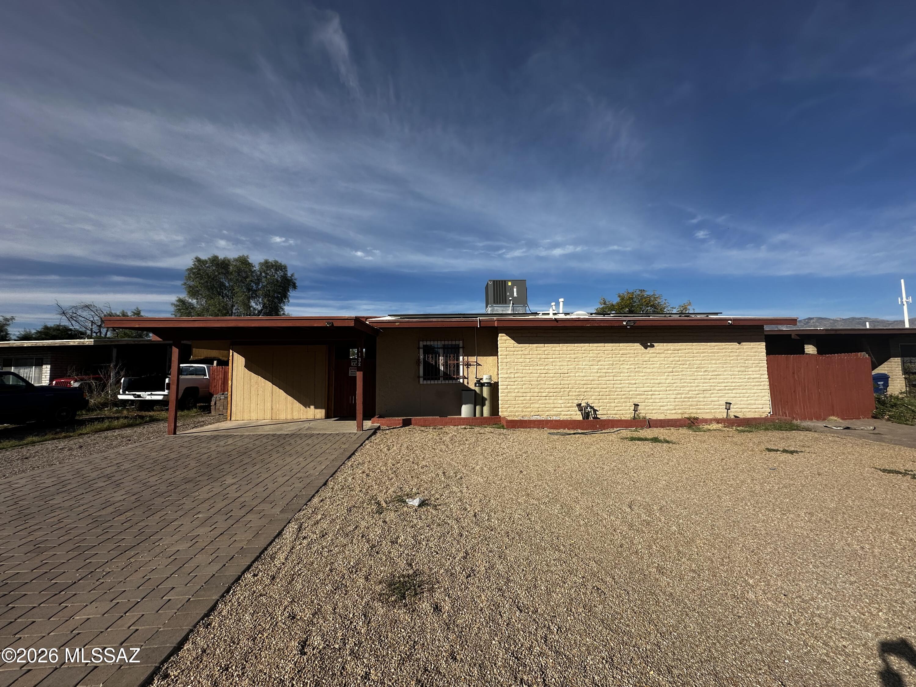 This spacious 1,322 square foot single-story home features 5 bedrooms and 2 full bathrooms in Tucson's desirable Westwood Terrace Estates neighborhood. The open floor plan creates an ideal entertaining space with tile flooring throughout the main living areas. The well-appointed kitchen includes all major appliances: refrigerator, oven, microwave, dishwasher, plus convenient water RO system and water softener for quality drinking water. Bright living areas showcase the home's comfortable single-level design with plenty of natural light. The thoughtful layout provides 5 nicely sized bedrooms offering flexibility for families, home offices, or guest accommodations, while 2 full bathrooms ensure convenience for daily routines. Laundry is made easy with included washer and dryer. Solar panels are a plus with the heat in the summer. The attached garage provides covered parking and additional storage space. Step outside to enjoy the private backyard featuring a covered patio perfect for outdoor dining and relaxation, all within a fully fenced yard for privacy and security. Located in the established Westwood Terrace Estates community, this home offers excellent access to local schools, parks, shopping, and dining throughout Tucson. The neighborhood provides a peaceful residential setting while maintaining convenient access to major corridors for easy commuting.