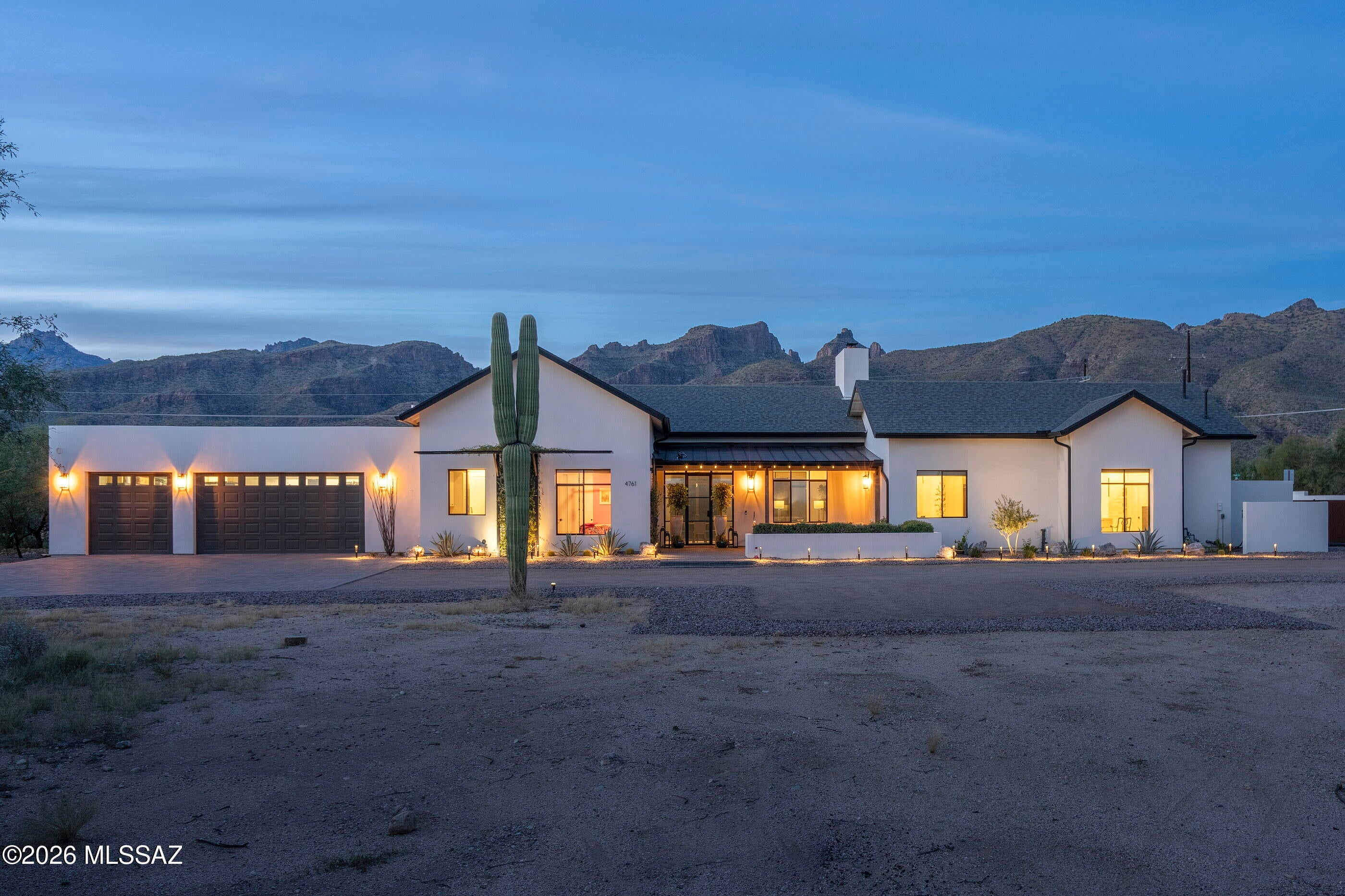 Modern farmhouse living meets the best of Arizona lifestyle! Built in 2022 & set on a private 1.8-acre corner lot, this stunning home offers gorgeous Catalina Mountain views, resort-style backyard, & flexible floor plan w/room for everyone. Light, bright, & beautifully designed, the home features vaulted ceilings, exposed beams, engineered wood flooring, commercial-grade windows and doors,& a spacious great room w/gas fireplace. The show-stopping kitchen offers quartz countertops, stainless steel appliances, floating shelves, beautiful custom cabinetry, a large walk-in pantry, built-in desk, & abundant storage. A mudroom & split-bedroom floor plan make everyday living easy. The primary suite  feels like its own private retreat w/his/her walkin closets, a dressing/exercise room. Attached to primary bathroom don't miss the private courtyard complete with an outdoor shower. A separate office with its own entrance to the front patio creates an ideal work-from-home space. Step outside to an incredible backyard designed for year-round Arizona living and entertaining. Enjoy the newer heated pool and spa, gazebo, artificial turf, expansive covered patio, and built-in BBQ--all surrounded by space, privacy, and mountain views. There's even a fenced dog run with artificial turf. The three-car garage features epoxy flooring and additional storage. Ideally located near Arizona National Golf Club, Bear Canyon Trailhead, and an easy drive to Mt. Lemmon. Private, stylish, spacious, and built for entertaining--this is a truly special Tucson home. See the attached floor plan and complete list of features and amenities.
