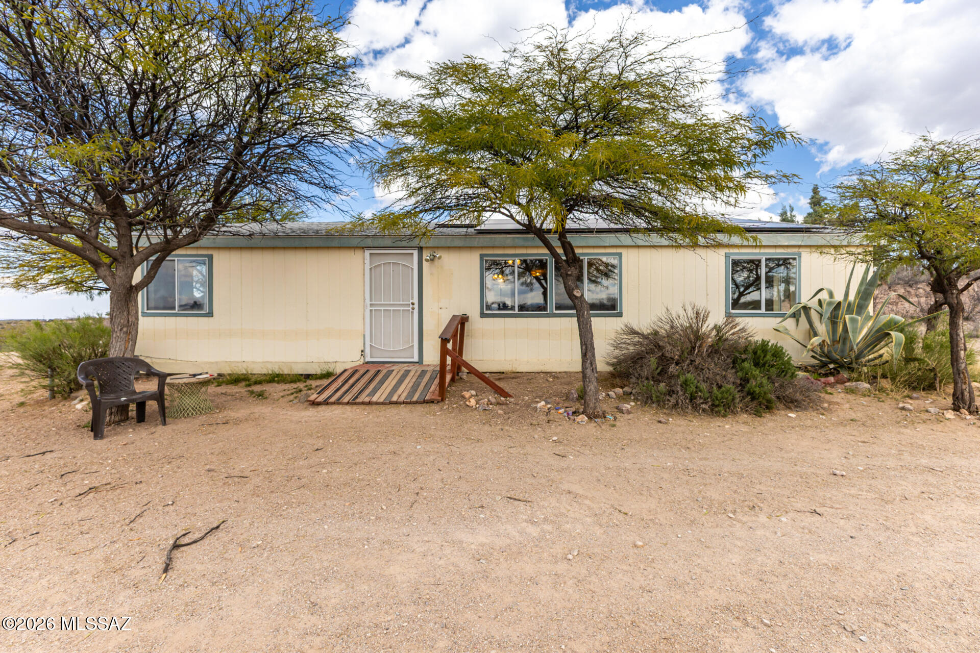 Desert Dream home alert. Find peace on your own 1.29 acre property. 2 Bed 2 bath home w/ fantastic desert views. Very well maintained w/ UPDATED appliances. NEW 30 yr ROOF shingles in 2020! NEW SEPTIC & LITCHFIELD 2026! OWNED SOLAR! NO HOA. Inside, you'll find inviting living spaces with wood-look flooring, tile in all the right places, vaulted ceilings, abundant natural light, and neutral paint throughout. Kitchen is equipped with plentiful storage cabinetry, spacious counters, and built-in appliances for a seamless cooking experience. The primary bedroom is a true retreat, boasting sliding doors to the back that offer beautiful views and a private bathroom. Inside laundry room for convenience. Out back, you can enjoy a refreshing drink the serene mountain and desert scenery.