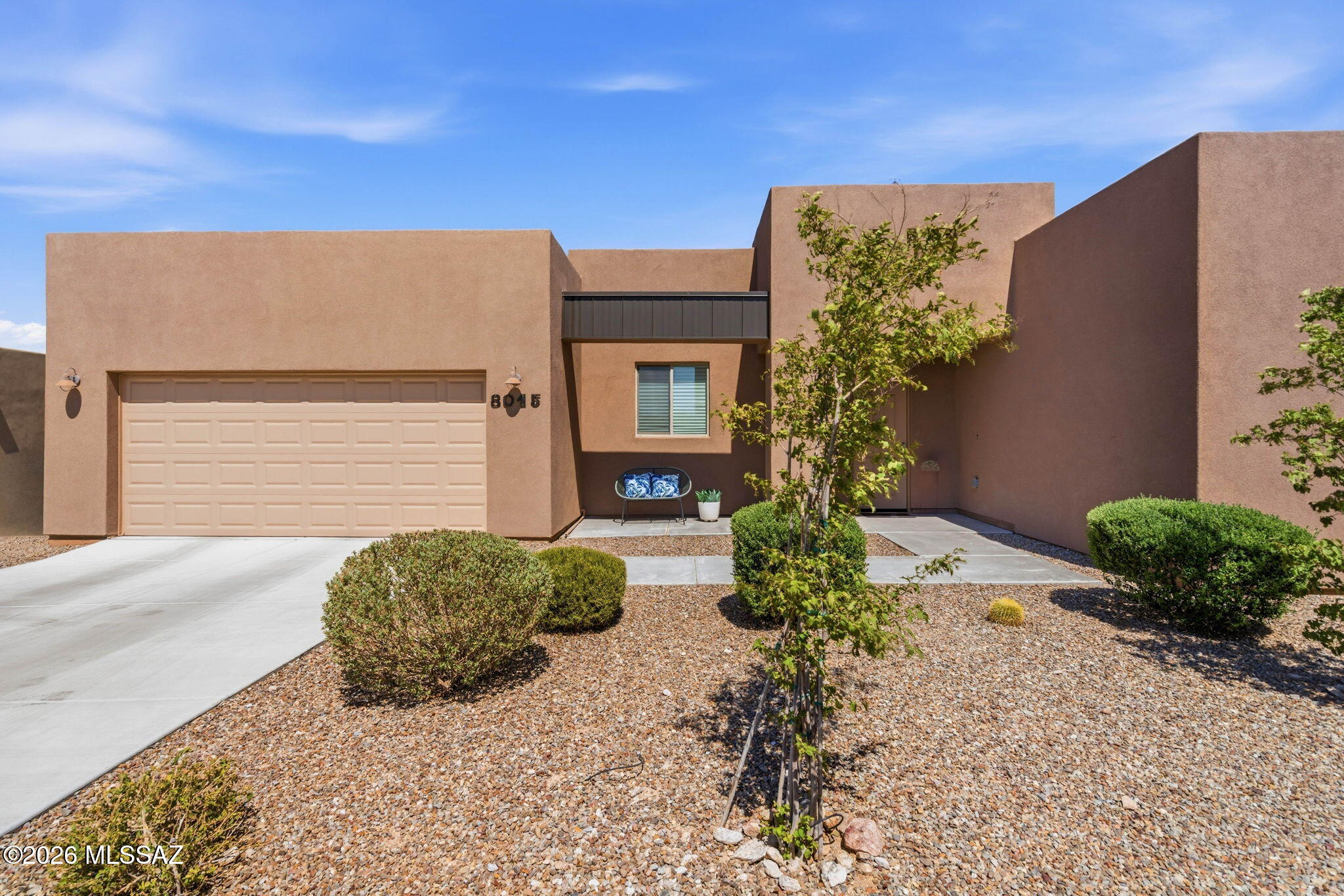 Built in 2022, this 3 bedroom residence rests on a generous lot with wide-open mountain vistas and no homes behind for added privacy. Located within the vibrant Academy Village, where neighbors connect through art, pottery, game nights, and a top-tier fitness center, this nearly new home is ready for your personal style to shine. The upgraded kitchen opens seamlessly to a wall of sliding glass doors, creating a perfect stage for indoor-outdoor gatherings framed by the Rincons and surrounding desert landscape. Step out to the extended covered patio, additional front entry hardscape, and a backyard with room to design the pool or outdoor kitchen you've always imagined. Inside, neutral tones set a calm backdrop for any décor. Experience the best of modern construction without the wait, paired with the lifestyle of an engaged, and state of the art welcoming community.