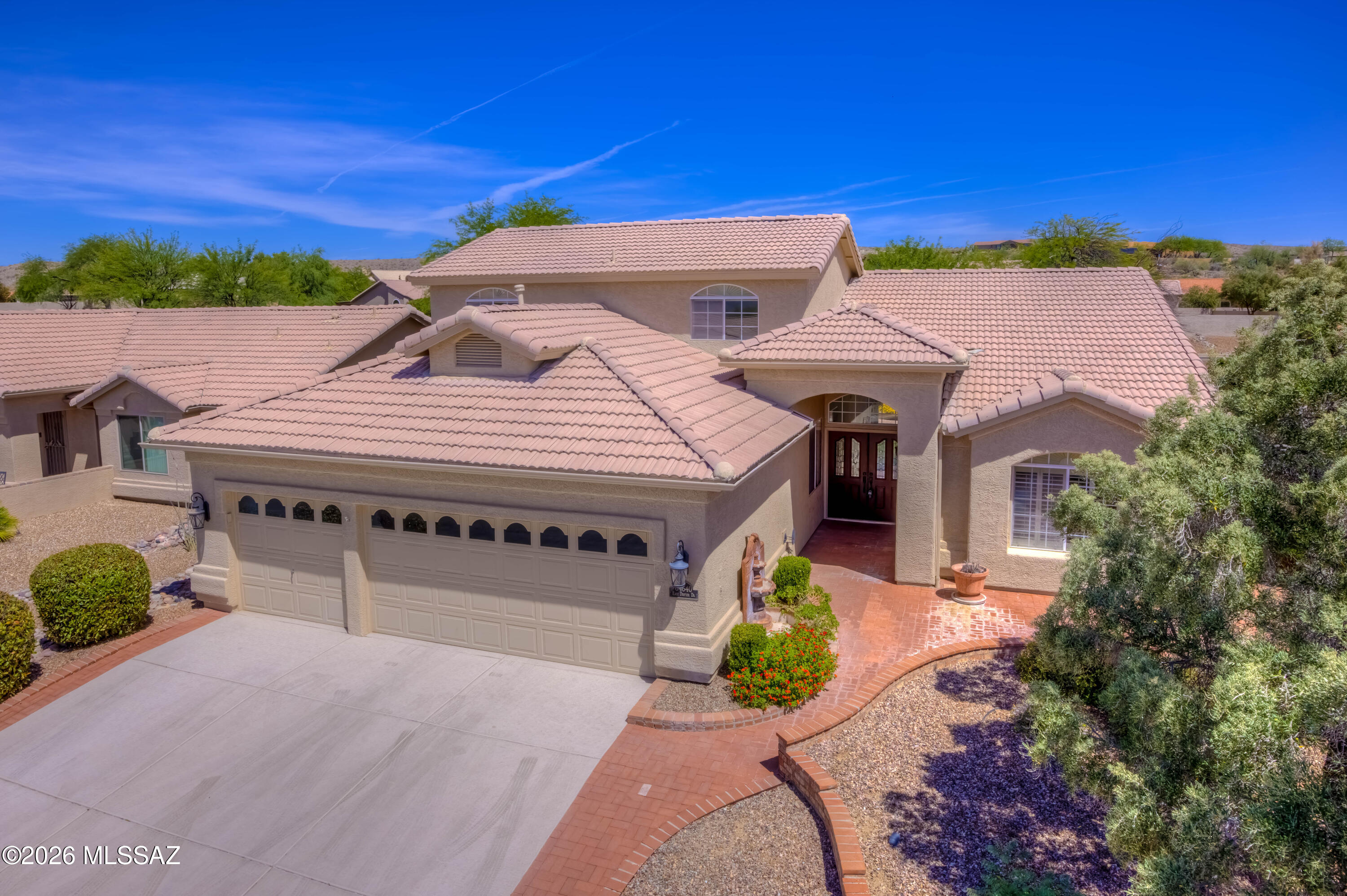 Exceptional Value in Saddlebrooke! Welcome to this beautifully maintained home in Saddlebrooke, where soaring vaulted ceilings and an abundance of natural light create a bright, airy atmosphere from the moment you walk through the door. Start your mornings in the charming front courtyard with sweeping mountain views. Designed for effortless living, the floor plan places everything you need on the main level-Primary suite, office, powder bath, laundry room, and a stunning living room/dining room/family room(with fireplace). The entertainer's kitchen features Corian counters, induction cooktop, walk in pantry and newer appliances. Upstairs, two guest bedrooms and a full bath create a private retreat for family or visitors. The covered patio with built-in BBQ is ready for Arizona Evenings! The over-sized 2.5 car garage includes built-in cabinets, a workbench, and a dedicated golf cart bay. At $475,000, this is an amazing value in Saddlebrooke-Southern Arizona's premier active Adult Community. HVAC-2019, Water Heater-2020, Whole home re-piped-2024, Irrigation lines replaced 2023.