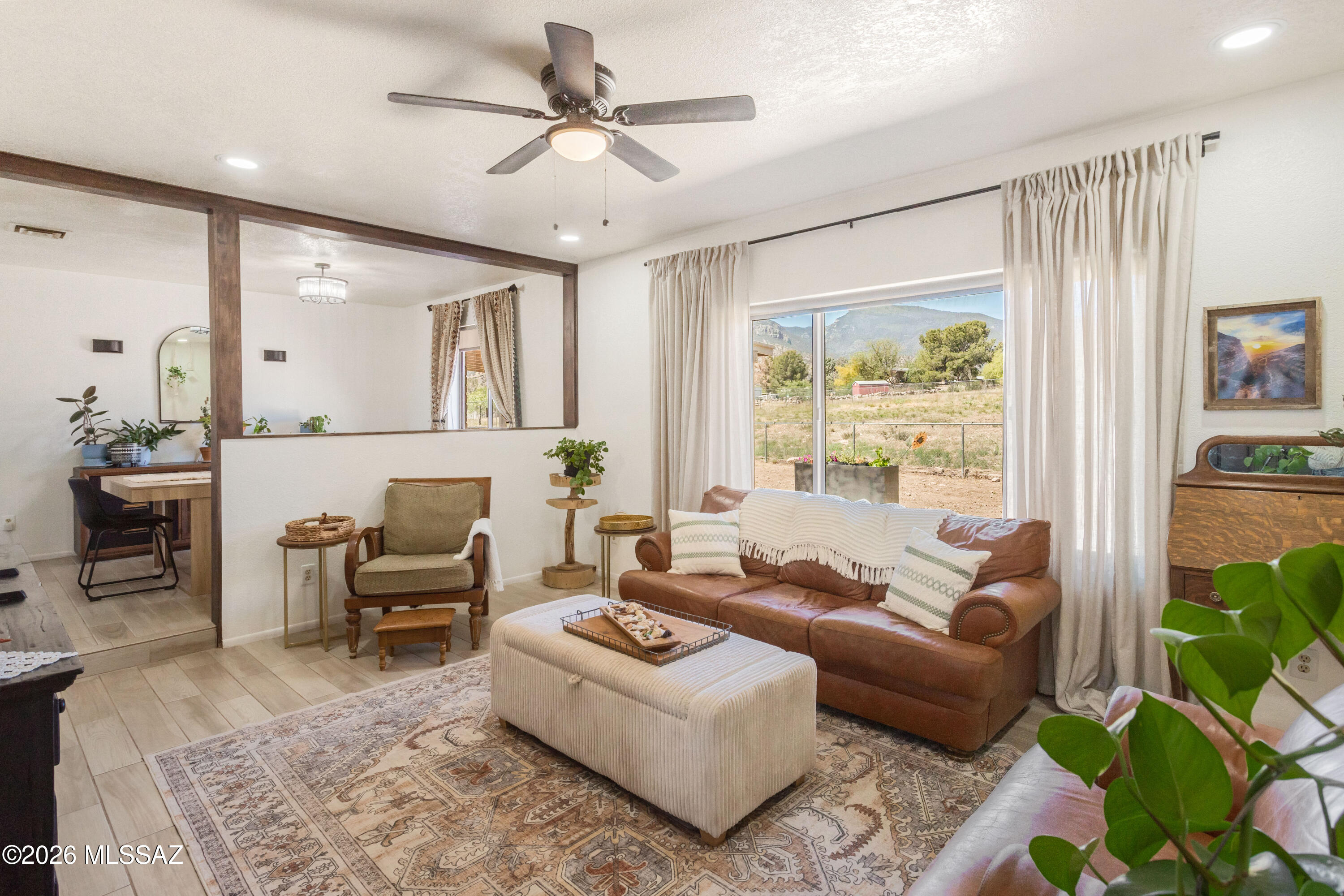 Sitting on a spacious 1.229-acre lot in the highly sought-after neighborhood of Pueblo Del Sol, this exceptional property offers stunning views of the Huachuca Mountains, versatile living spaces, beautifully updated interiors, and no HOA.

The main residence features 3 bedrooms, 2.5 bathrooms, and an extended 2-car garage with a separate storage/workshop area. Thoughtful updates include new kitchen appliances (2024), remodeled kitchen and bathrooms (2025), and wood-grain tile and LVP flooring throughout.

Enter through the meticulously landscaped central courtyard, creating a warm and inviting first impression. Inside, you'll find a bright and open living room with a spacious dining area, along with a separate family room just off the kitchen, complete with a cozy wood-burning fireplace and charming tongue-and-groove ceiling. The kitchen serves as the heart of the home, featuring granite countertops, Samsung appliances, ample cabinet and counter space, an oversized pantry, and a dedicated coffee/bar station, perfect for both everyday living and entertaining. The fully fenced backyard is expansive and private, offering two covered patios and breathtaking mountain views, creating the ideal setting to relax or host guests.

Adding incredible flexibility, the property also includes a separate guest house with 1 bedroom, 1 bathroom, a living area, kitchenette with full-size refrigerator, and its own 1-car garage. Equipped with its own HVAC system and water heater, this space is perfect for guests, extended family, or potential rental income.

With its combination of modern updates, multi-generational living potential, and serene desert surroundings, this is a rare opportunity and a must-see.