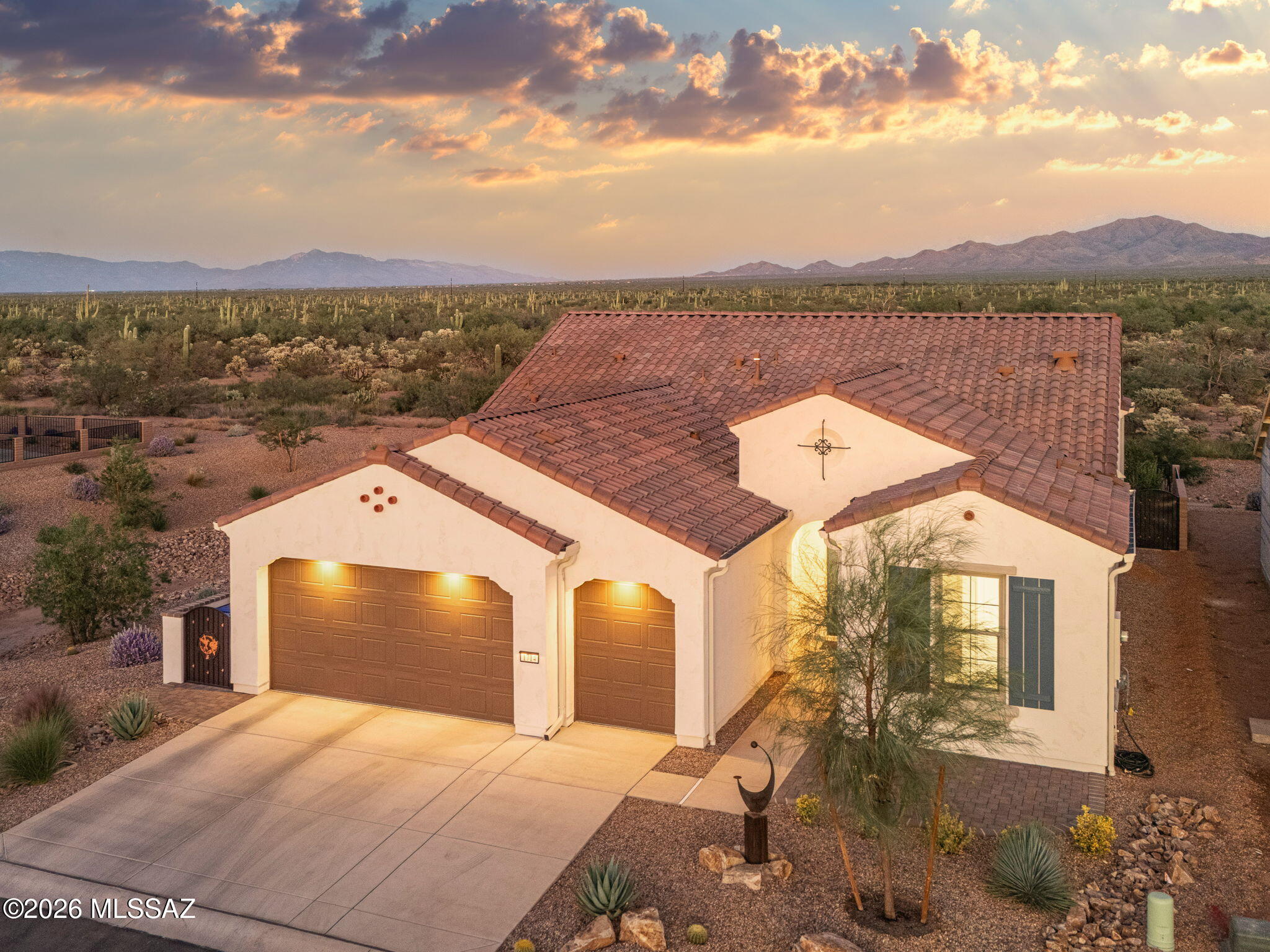 Views, privacy and sunshine without the wait! You'll feel it the moment you step onto the back patio. Open desert stretches out before you and the majestic Santa Rita Mountains rise in the distance with no homes to be built behind you. Set on a premium lot with no direct neighbor to the north, this is the kind of privacy and view buyers search for and rarely find. Step inside and feel instantly at home. This better than new Fresco model in Robson's Quail Creek gives you all the joy of a brand new home without the long build wait. Sunlight pours through the open floor plan, making every room feel bright, airy and welcoming. A formal dining room sets the stage for dinner parties with new friends and the open living space keeps everyone connected when family comes to visit. Outside, your backyard is pure Arizona magic. Sip your morning coffee on the covered patio as the desert wakes up, let the gentle sound of your stunning water feature melt the day away and enjoy lush green turf with none of the upkeep. As evening falls the Santa Ritas glow in shades of rose and gold. Later, step back outside to a sky so full of stars you'll wonder why you didn't move here sooner. Golf in the morning, pickleball with friends, lazy afternoons by the pool and sunshine nearly every day of the year. While others shovel snow, you'll be hiking Madera Canyon or lingering over lunch on the patio. This is the active Arizona lifestyle you've been dreaming about and this home puts you right in the heart of it. Come for the views, stay for the lifestyle and make this beautiful Quail Creek home your own.