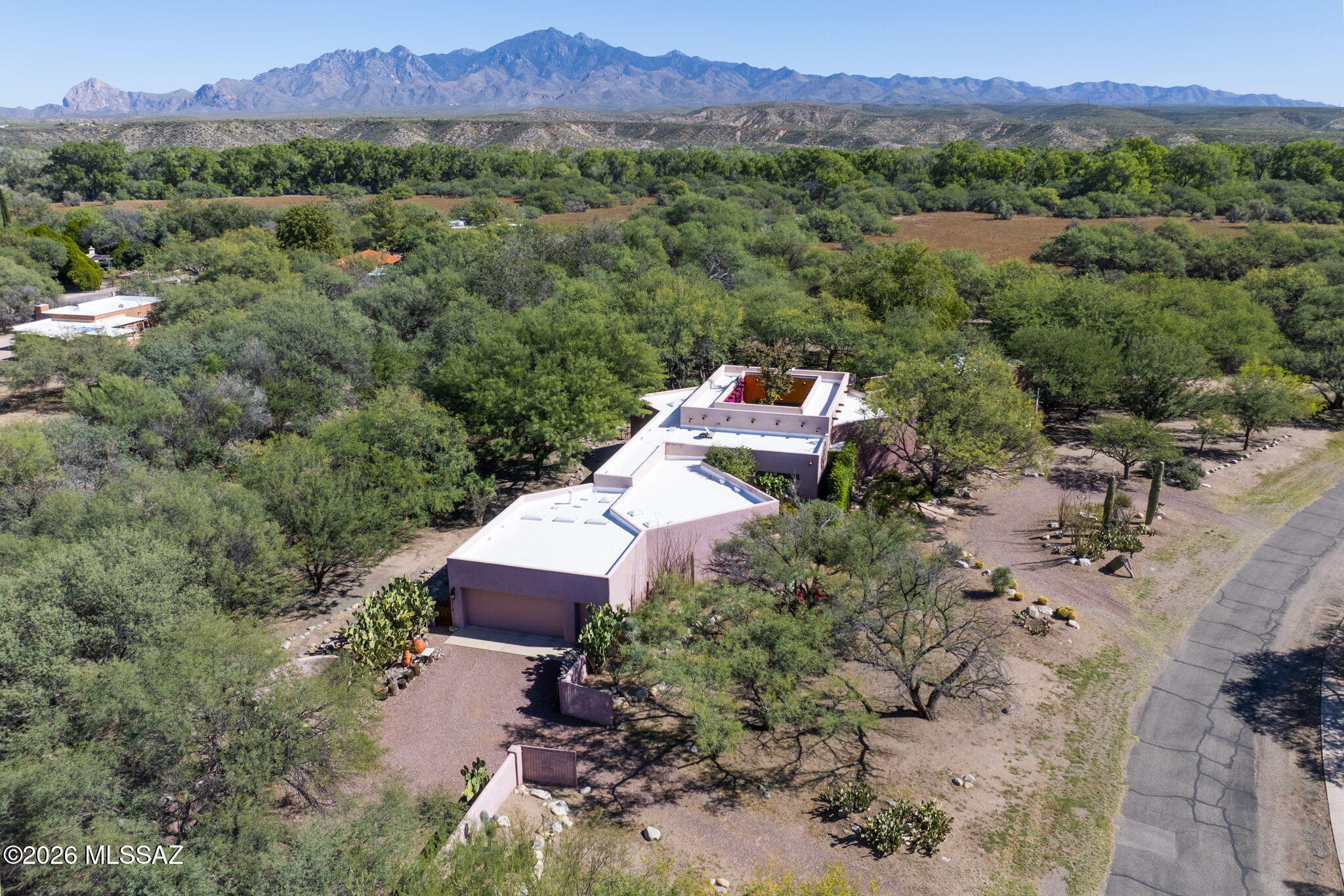 This is a beautiful 4211 square-foot single-family residence located on a very private 1.3 acre lot with an additional adjacent lot available for added privacy. The main house is 3768 sqft with an additional 443 sqft pool/entertainment house. The lap pool and the pool house were added in 2020 and provide a resort like ambience. This is a custom home designed by the architect/owner with many aesthetic details. The house is designed around the central courtyard creating a bright open atmosphere. The house flows via hallways to circle the courtyard allowing for extra light and a view of the sky. There is a separate gated entrance to the pool area which is very convenient for social gatherings. If you desire you can have a party or an event without your guests having to enter your home.
