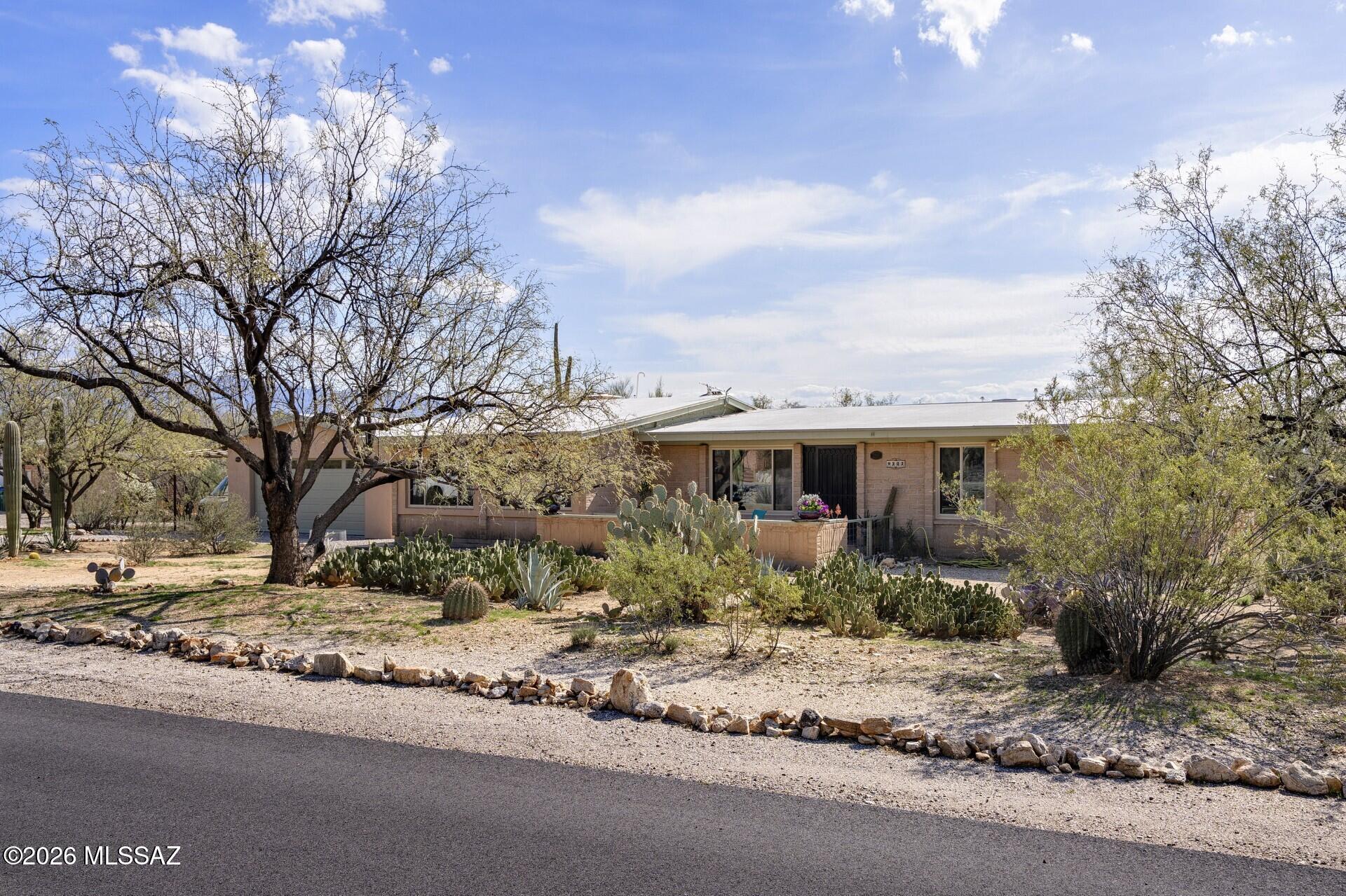 This Classic Tucson Ranch home has no HOA and is situated on nearly 3/4 of an acre on a cul-de-sac street. Facing North, the large living room windows have a spectacular full view of the Catalina Mountains which can also be enjoyed while sitting out in the front courtyard. The great room/studio also
takes advantage of the Catalina views & has its own mini split for heating & cooling. Storage areas are in abundant supply with an oversized laundry room and an additional walk in storage closet. Kitchen and baths have granite countertops for easy use. Enjoy a wonderful backyard from the extended back patio off the kitchen/family room. On cooler nights, enjoy the fireplace that has been plumped for gas. Detached garage is oversized & there is a covered 3rd parking spot for the extra vehicle.