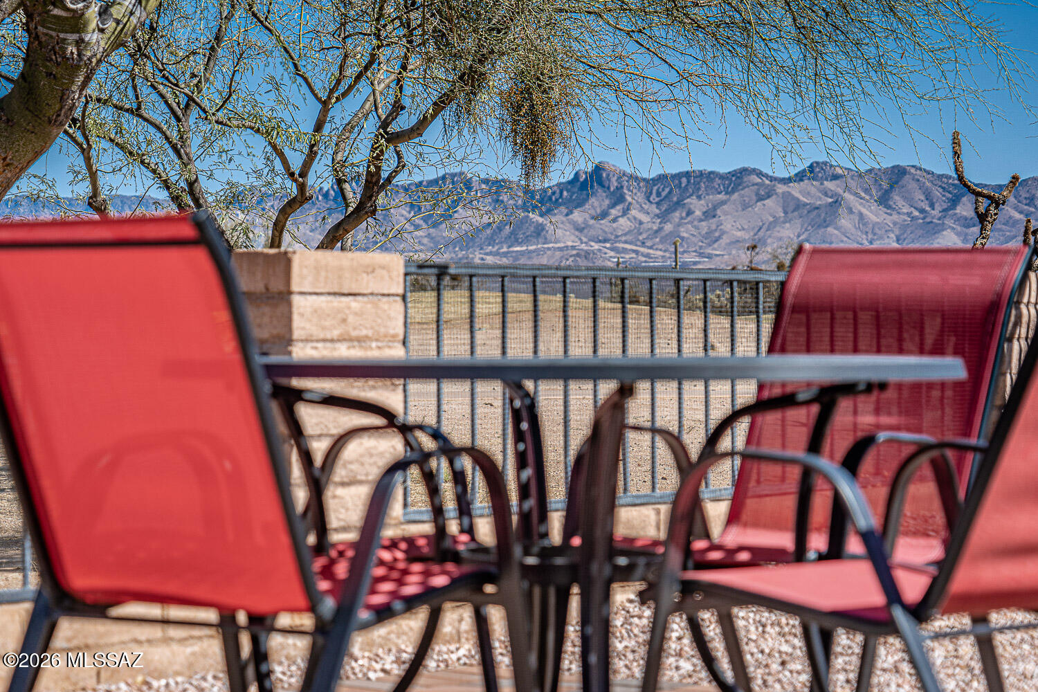 Positioned on a premium golf course lot with sweeping mountain views, this beautifully upgraded home offers exceptional value within an exclusive gated golf community. A dramatic wall of windows frames the lush fairways and desert backdrop, filling the home with natural light and unforgettable scenery.
Custom finishes are showcased throughout, including a thoughtfully designed kitchen with raised panel cabinetry, under-cabinet lighting, roll-out shelving, engineered stone countertops, tile backsplash, and a center island topped with granite. Enjoy cooking with the inset cooktop, built-in oven and microwave, oversized farmhouse sink, and new refrigerator. The owner's suite is a private retreat, entered through double doors and featuring a cozy sitting area, patio access, and a spa-inspired en-suite with soaking tub, dual-head walk-in shower, and custom closet built-ins. Guests will appreciate the detached casita with its own full bath and kitchenette. Additional highlights include dual HVAC systems, central vacuum, whole-house water conditioning, an extended garage with golf cart space, and a new roof (2023). Relax on the covered flagstone patio and take in breathtaking sunrises and cool afternoon shade.