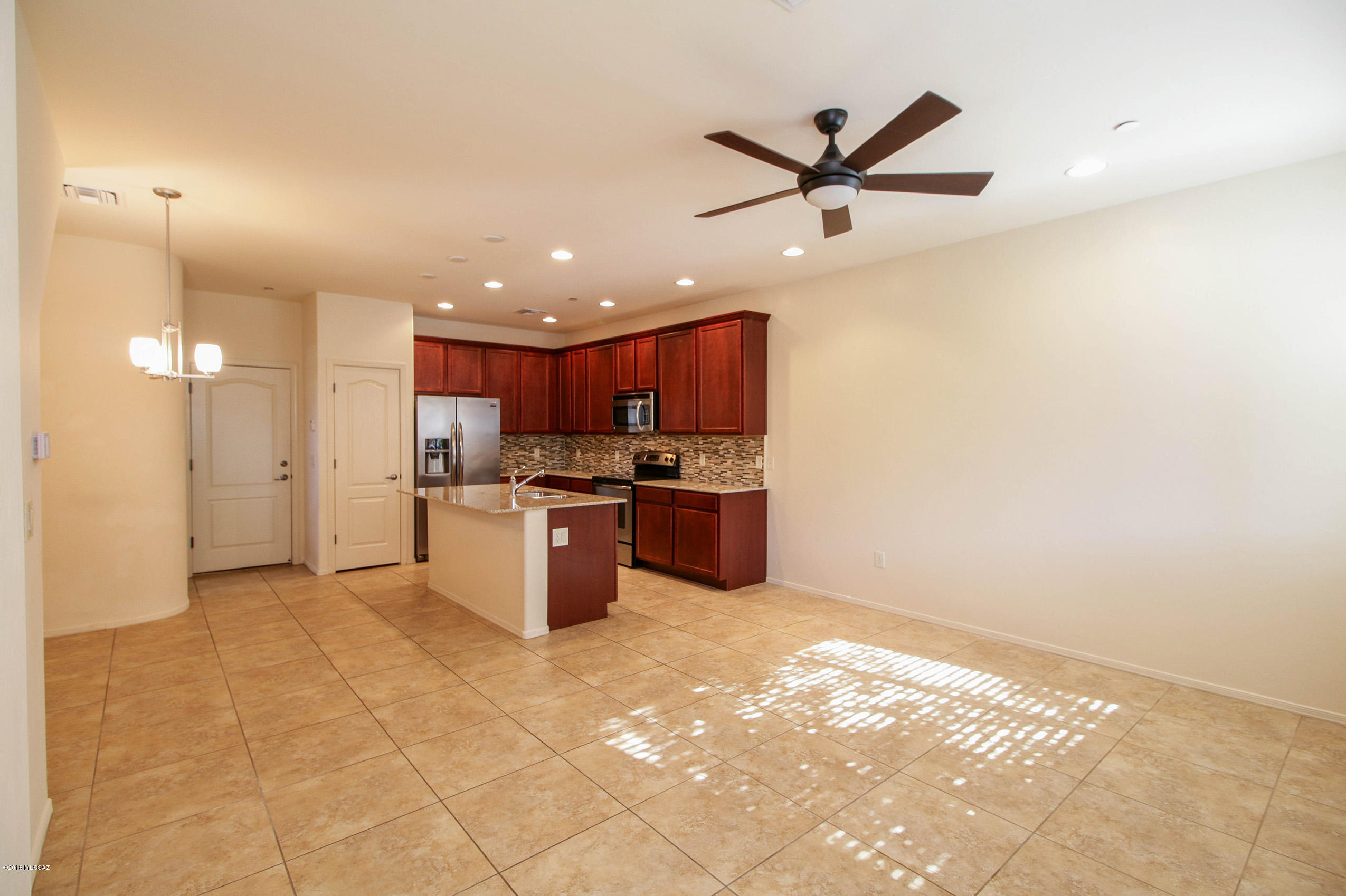 Gorgeous 3 story condo at River Walk. This home has contemporary styling and bright sunny rooms due to this units extra windows. SS appliances, granite counters and 42'' upper cabinets in kitchen, 9 ft ceilings throughout. Kitchen and hallway windows have plantation shutters-2 inch blinds on all other windows. Brand new carpet. Lg master bedroom with walk-in closet, 20'' porcelain tile on lower level. Master bath has custom tile work. Large 3rd level family room plus adjacent rooftop deck makes for a great play space for friends & family! Big plus! Garage and powder room easily accessible on first floor near kitchen. A must see!!