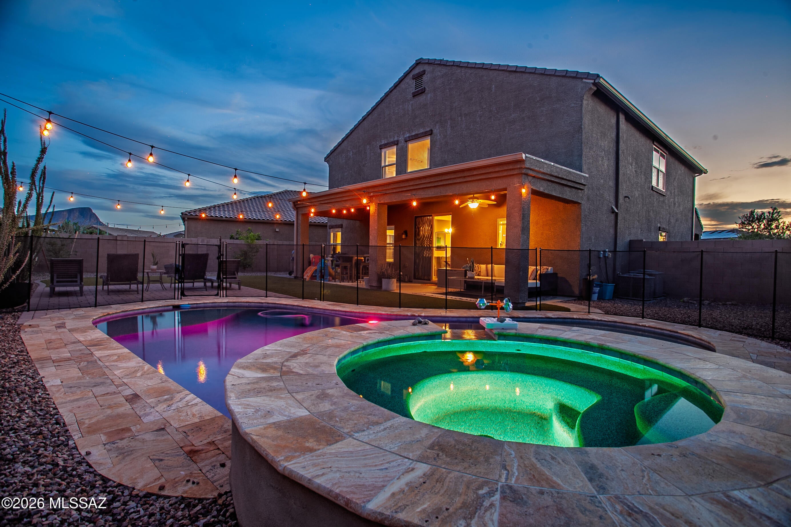 2.99% ASSUMABLE RATE! Gorgeous 2021-built 5-BED 3-BATH 1 LOFT 3-CAR GARAGE Torino model in desirable Palo Brea-Saguaro Bloom! This wonderful like-new home offers a bright & open floorplan, 9ft ceiling & lots of natural light. Beautiful kitchen features separate coffee station, big island, granite counter, white cabinetry, SS appliances & walk-in pantry. 2 spacious living rooms & 2 separate dining areas. Primary suite offers dual vanities, separate garden tub, walk-in shower & walk-in closet. Upstairs laundry room is pre-plumbed for sink. Enjoy one of the biggest private lots in the neighborhood. Amazing backyard offers HEATED sparkling pool & hot tub, mountain view, turf, full-length covered patio. Resort-style community pools, hot tubs, gym, clubhouse, splash pad, parks & basketball court Owned Solar adds energy savings. Water softener and water reverse osmosis system convey.