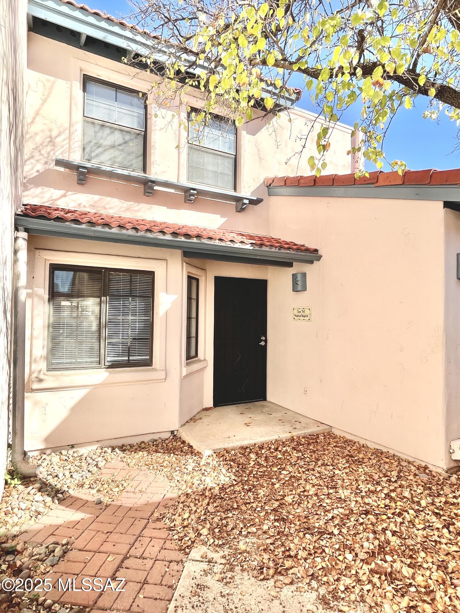 Enter thru your own gated courtyard and enjoy the privacy of this spacious 3 bed 3 full bath Encanto Court townhome within walking/biking distance of the University of Arizona. This 2-Level townhome has a large Living/Dining Room with a wood burning Fireplace, high ceilings allowing plenty of light, and access to a private Covered Patio. The Kitchen has a separate Breakfast Nook and plenty of counter space. One Bedroom is located at the ground level with a full Bathroom off Hallway. The Primary Bedroom is very spacious, and equipped with a Double Sink Vanity, separate bathtub and shower and HUGE Walk-in Closet. The third Bedroom has it's own en suite Bathroom and overlooks the front courtyard and 2 Car Garage. Community Pool & Spa just steps away.