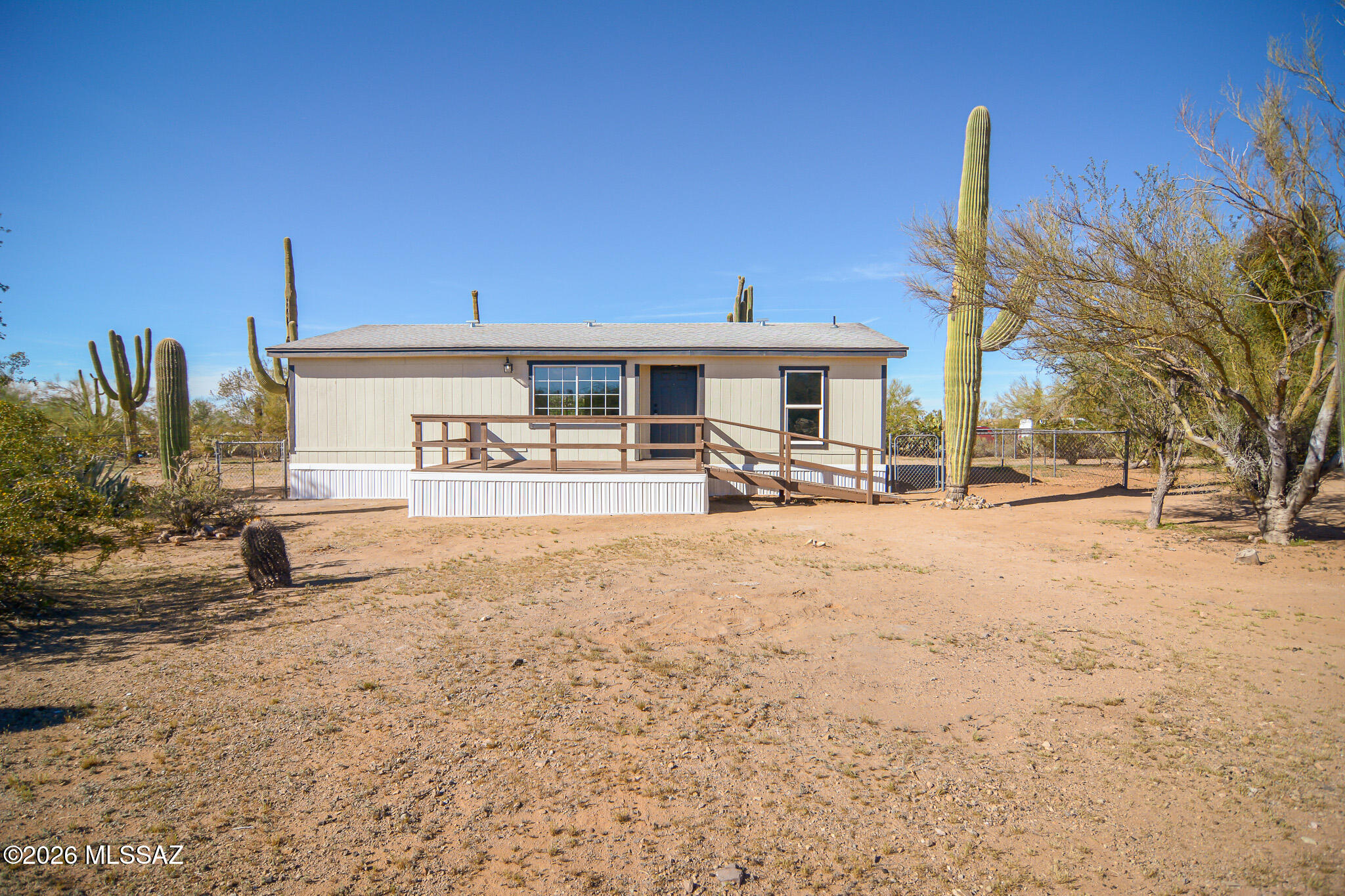 Beautifully remodeled Manufactured home. Located in a scenic Northwest Marana location. Rich wood look luxury vinyl plank flooring. New kitchen features SS appliances. New upgraded carpet and padding in bedrooms. Celing fans in each room. New ceramic tile in bathrooms. New interior and exterior paint. Storage shed. Mountain and sunrise/sunset views. On approximately 1 acre land. This home shows beautifully.