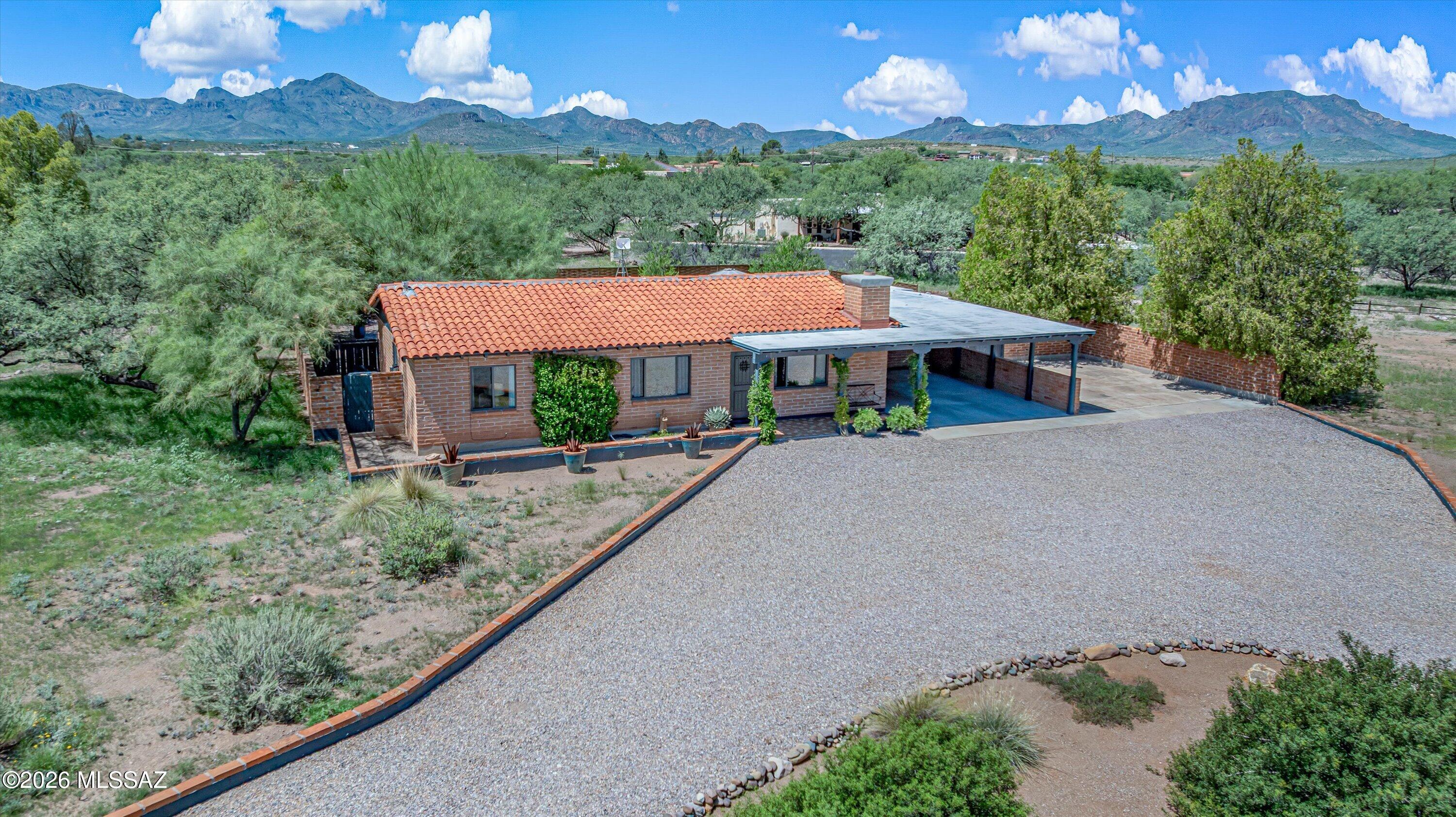 Beautifully remodeled Tubac home on a spacious .83-acre lot, blending authentic Southwestern character with stylish modern updates. This 3-bedroom, 2-bath home features a stunning remodeled kitchen with large island, stone countertops, stainless appliances and gas range, plus beautifully updated baths with tiled walk-in showers. Bright, inviting living spaces and an additional artist studio/bonus room with its own mini-split provide exceptional versatility. The professionally designed backyard features thoughtfully selected desert vegetation chosen with expert guidance for Southern Arizona's climate, sun and low-water conditions, creating an inviting outdoor retreat.  click more!!! From the moment you arrive, this home offers a wonderful combination of Southwestern charm, thoughtful renovation and comfortable desert living. The classic exterior and established setting give the property a distinctive Tubac character, while extensive interior updates create a fresh, contemporary feel.

The remodeled kitchen is truly the heart of the home. A generous center island provides abundant workspace as well as casual seating, complemented by stone countertops, stainless steel appliances, a gas range, contemporary cabinetry and attractive open shelving. The kitchen flows naturally into the adjoining living areas, creating an open and comfortable environment for everyday living and entertaining.

Both bathrooms have been beautifully updated, including impressive tiled walk-in showers, contemporary fixtures and attractive finishes. The home's bright interior, clean lines and carefully chosen materials create a relaxed atmosphere while retaining the warmth and personality expected in a Tubac home.

A separate artist studio/bonus room with its own mini-split heating and cooling system adds tremendous flexibility. Whether used as an art studio, creative workspace, home office, exercise room, hobby room or private retreat, this additional space is a valuable feature that allows the home to adapt to a variety of lifestyles.

Even the laundry room has received special attention, with attractive cabinetry, countertop space and a utility sink, providing both functionality and storage.

Outdoor living is an important part of this property. The professionally designed backyard was thoughtfully planned to complement the natural Southern Arizona environment. Vegetation was selected and placed with expert guidance, emphasizing varieties well suited to the desert climate, abundant sunshine and low-water conditions. The result is an attractive outdoor environment that enhances the home's setting while remaining appropriate for desert living.

With approximately .83 acre, the property provides a sense of space and privacy that can be difficult to find while still enjoying convenient access to the Village of Tubac. The generous homesite provides room to enjoy the outdoors, entertain guests, relax and appreciate the surrounding landscape and Southern Arizona climate.

Located near the heart of Tubac, the property offers convenient access to the area's renowned art galleries, restaurants, shops, golf and outdoor recreation. Tubac's unique combination of history, art, natural beauty and relaxed lifestyle has made it one of Southern Arizona's most distinctive communities.

Move-in ready and thoughtfully improved throughout, this property offers much more than its bedroom and square-footage numbers alone suggest. The combination of a remodeled interior, beautiful kitchen and baths, versatile artist studio/bonus room, professionally designed desert landscaping and generous .83-acre setting creates a home with character, functionality and a lifestyle that is difficult to duplicate.