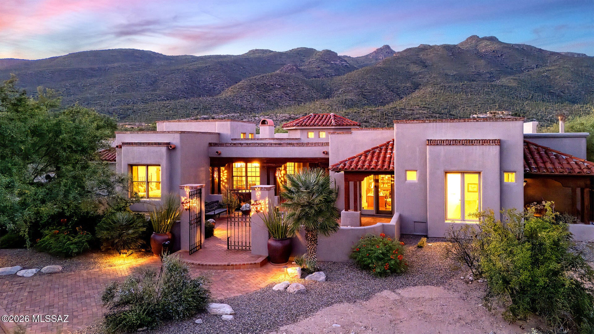 EXCEPTIONAL SOUTHWESTERN ESTATE ON 7.95 ACRES . . . PRIVACY, ARCHITECTURE & ENDLESS POSSIBILITIES.  A truly remarkable Southwestern Territorial estate set within the prestigious gated community of Fetzer Ranch, where privacy, extraordinary craftsmanship and breathtaking desert surroundings come together on an expansive 7.95-acre homesite. Built by acclaimed master builder Glenn Bender of Bender Builders, this distinctive residence reflects the character and quality of a custom home where no detail was overlooked and no corner was cut.  The property encompasses Lots 39 and 40, offering an exceptional opportunity for those seeking a private family compound, additional guest residence or simply an extraordinary amount of land surrounding their home. Keep the entire acreage for ultimate privacy, explore the possibility of selling the northerly lot, or create a second residence for family or guests.  A custom tumbled concrete paver driveway leads to a red brick walkway, through an elegant wrought-iron gate into a welcoming courtyard with fountain and distinctive Southwestern architecture. Inside, soaring ceilings and a dramatic blend of scored concrete, brick and Brazilian hardwood flooring, 8-foot knotty alder doors, Cantera stone accents and hand-hewn beams establish an atmosphere of warmth and authenticity.  The approximately 4,784-square-foot residence features 6 bedrooms, 4½ baths and an impressive 4-car garage, with generous living spaces designed for both grand entertaining and comfortable everyday living.  The living room showcases a beautiful Cantera fireplace beneath beamed ceilings with corbels, while the dining room features custom built-ins and a distinctive Mexican tin chandelier. A gallery/library provides abundant built-in bookcases, and a guest bedroom/office includes a convenient Murphy bed.  At the heart of the home is a superb chef's kitchen featuring a large center island, breakfast bar, breakfast nook, fireplace, designer stainless-steel appliances and professional gas cooktop. The gracious primary suite offers dual vanities, oversized walk-in closet, separate shower and luxurious jetted tub.  Throughout the home, solid alder doors, rich woodwork, Cantera stone, brick, custom details and Southwestern finishes create a sense of craftsmanship rarely found in today's construction. The expansive porches feature multi-colored mission tile roofs, while the rear living area opens to an extraordinary outdoor setting.  The resort-style backyard features a pool and spa with Cantera waterfall, expansive brick patios, built-in barbecue and a spacious covered rear porch with brick flooring and wood-beamed ceilings. It is an exceptional setting for entertaining, relaxing or simply enjoying the spectacular desert environment.  Numerous thoughtful improvements further enhance the property, including a custom paver driveway, newer custom family-room doors, newer garage doors and built-in cabinetry. The roof has been regularly maintained and was last recoated in 2025. Systems include Trane HVAC units installed in 2019, Pentair pool equipment, irrigation with drip system updated in 2021, and water heaters updated in 2023 and 2025.  A rare combination of custom Southwestern architecture, exceptional craftsmanship, resort-style outdoor living and nearly eight acres of privacy, all within a desirable gated Tucson setting. Whether envisioned as a private family retreat, multigenerational compound or simply a spectacular estate with room to breathe, 5036 N Creosote Canyon Drive is a property of uncommon scale, character and possibility.