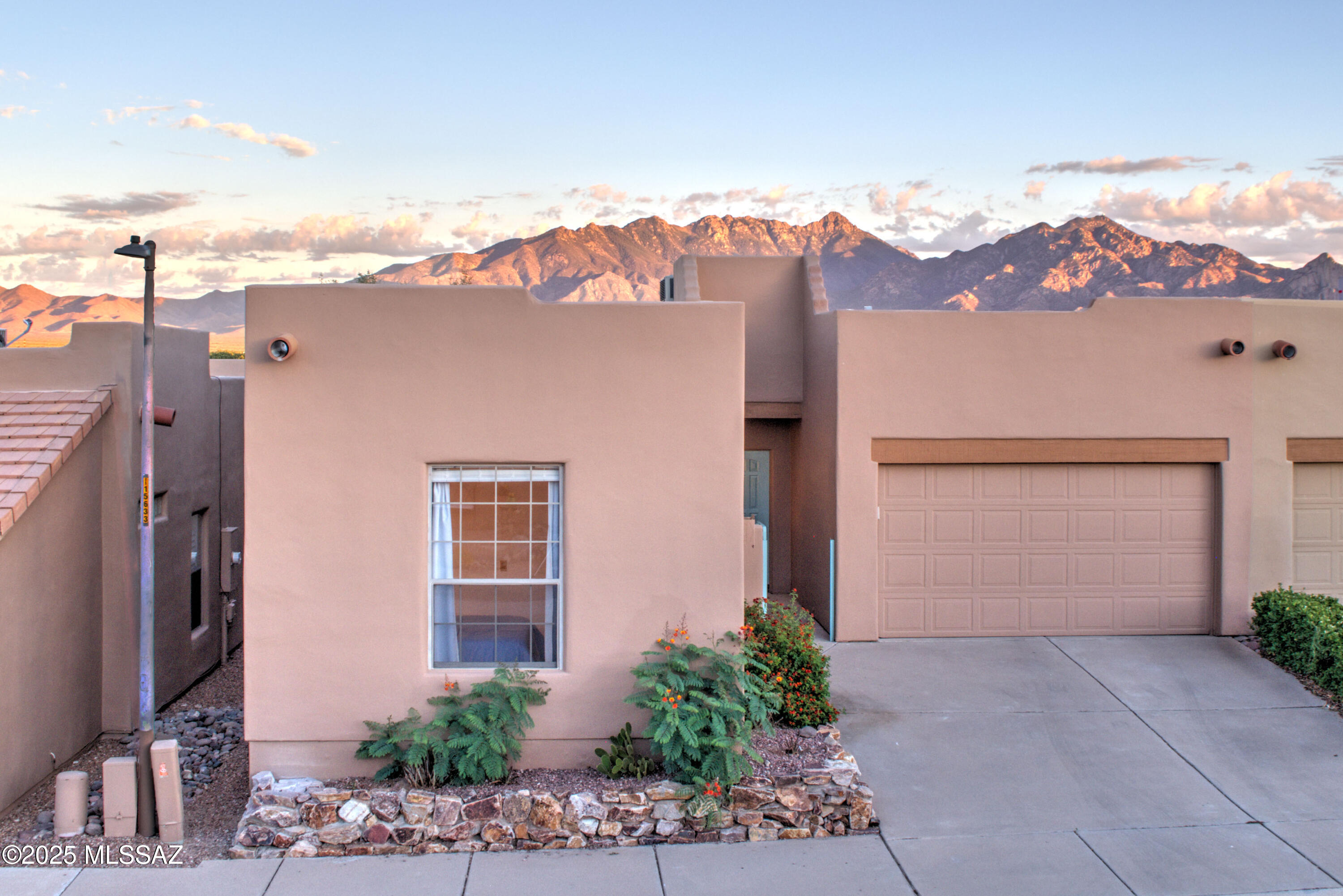 Inspiring views of the Santa Rita mountains inside and out, in this bright and sunny split bedroom townhome. Owner's suite offers patio access, 2 closets, walk-in shower - and yes, more mountain views. Bedroom number 2 can be a guest suite, home office, craft room, or all of the above - your choice! 1-car + golf cart garage, newer HVAC and water heater, and leased (transferrable) whole house water softener.  Your gated community is home to a premier Santa Rita Springs GVR recreation facility (fitness center, pool, clay studio, and more), as well as HOA maintained walking trails, cactus gardens and parks. Most furnishings convey. Move in ready! Enjoy!