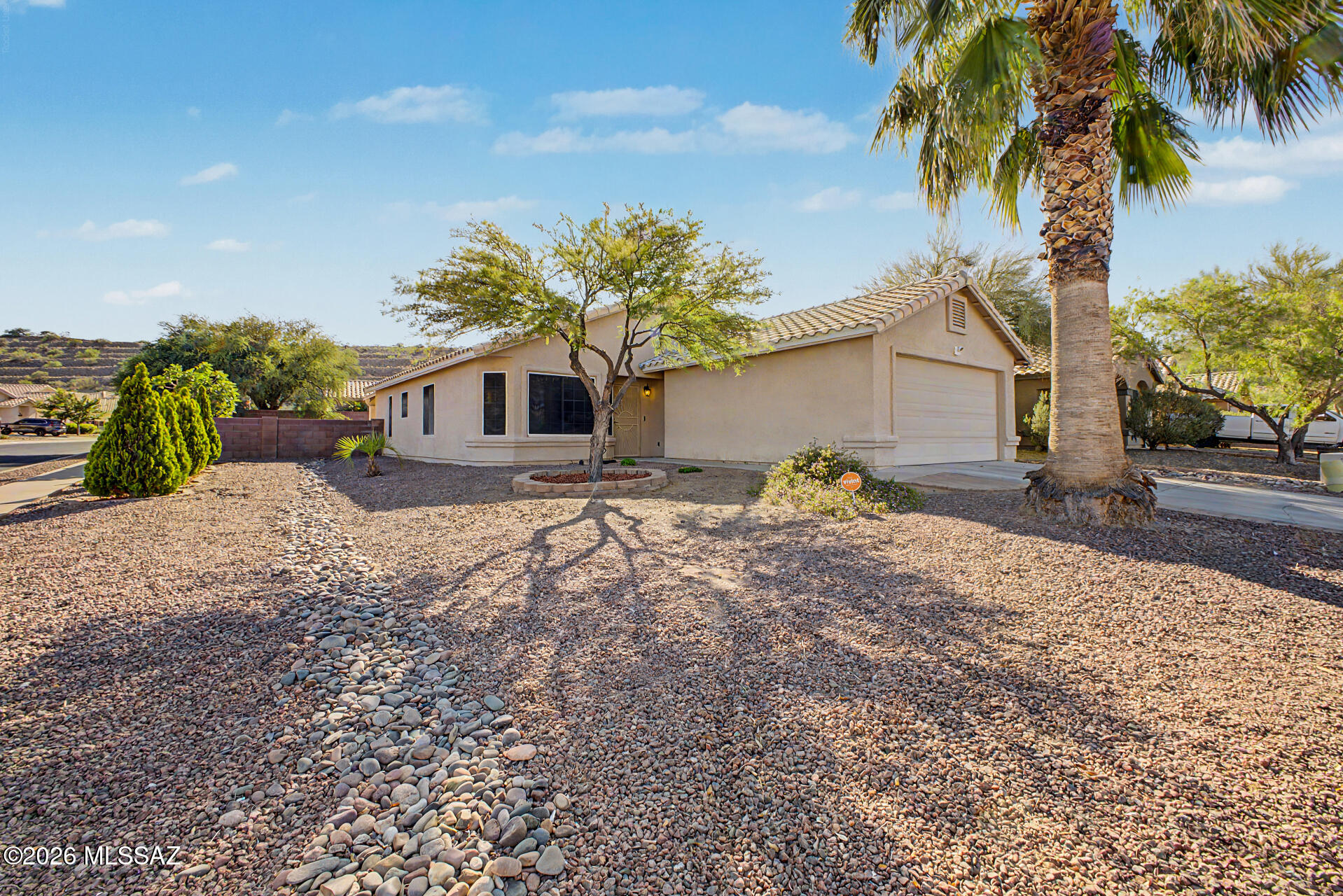 Look no further! This charming single-level home in Colonias La Canada is the one! Nestled on a corner lot, it offers 3 beds, 2 baths, 2-car garage, and a low-care landscape. The inviting interior features vaulted ceilings, tons of natural light and flowing floor plan. Excellent floor plan showcases a seamlessly flowing living & dining room w/bay window, alongside a separate family room w/sliding doors to the back. The kitchen has built-in appliances, wood cabinetry, a pantry, and a breakfast bar. The main bedroom boasts a walk-in closet and a full bathroom for added comfort. If you want to relax or have a fun gathering, the spacious backyard awaits you with an extended covered patio! Close to the I-19., New roof in 2025. Move-in ready!