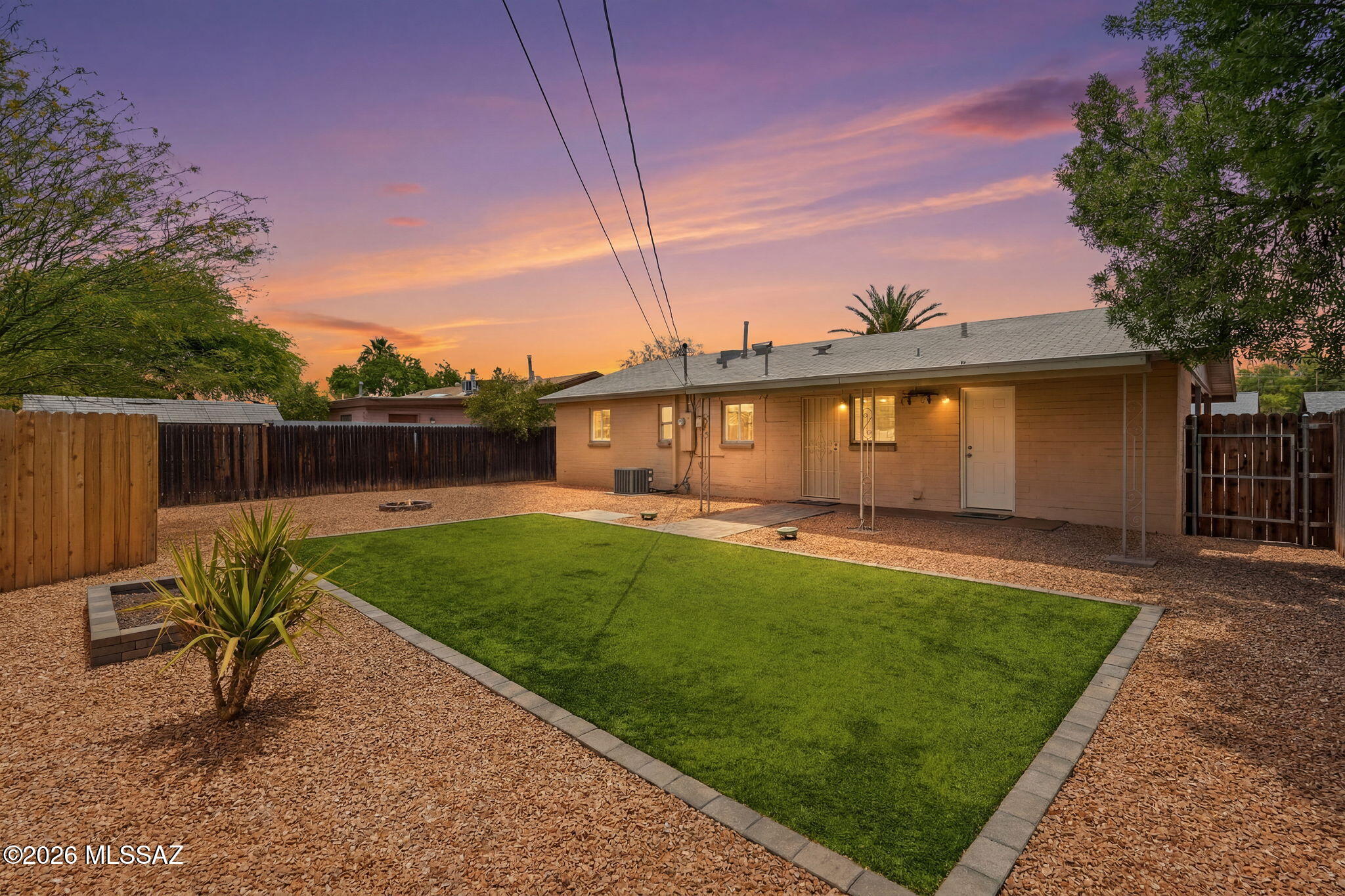 Amazing opportunity for affordable turnkey 3 bedroom/1 bath, single story 1951 masonry stucco Mid-Century Modern ranch home on .14 acre R-2 lot, the freedom of no HOA, covered carport, on and off street parking, in thriving Central Tucson. Priced below the $300,290 RVM property value, the perfect solution for those looking for an Airbnb investment property, long term rental, seasonal visitors (no stairs/no steps), secure student housing, first time home buyers, or anyone searching for a low maintenance home. Excellent Central Tucson location, boasting a 94 Biker's Paradise score, minutes away from the University of Arizona and Banner Medical! N/S orientation providing daily Catalina Mountain views, shingle roof, covered front patio, solid metal security doors, completely landscaped low maintenance front yard with fresh crushed decorative rock and granite boulders. Inside buyers will appreciate energy efficient double pane windows throughout, matching custom white wood blinds, freshly painted 2026, textured painted ceilings (no popcorn throughout), tile flooring (no carpet throughout), Rheem gas HVAC, Rheem gas water heater, updated full bathroom with tiled glass door walk-in shower with bench seating, rain shower head and exhaust fan, dedicated laundry room with washer and dryer included plus additional storage, 3 panel internal wood doors, ceiling fans with overhead illumination in bedrooms, spacious living room, dining area adjacent to cozy kitchen with gas stove, exhaust fan, white appliance package including 2025 LG refrigerator, dishwasher, brand new kitchen faucet, double sink with garbage disposal under garden window providing fantastic natural light.
Enjoy tranquil Tucson nights from under your covered extended back patio, appreciate the manicured landscaped backyard with always green artificial grass, raised flower garden, custom firepit, Belgard pavers, convenient side gate out for walks, recent crushed decorative rock, updated 200 AMP electrical, surrounded by privacy fencing.
Desirable Central Tucson location, enjoy fine dining at Culinary Drop Out, Postino, Snooze, Kingfisher, Blue Willow restaurants, walk to LA Madera Park, Conner Park and Tahoe Park, located just .5 miles from shopping/groceries/restaurants on Campbell Ave, minutes away from Banner Medial and the University of Arizona. Call to make your appointment to view this move in ready home today while it is still available!!