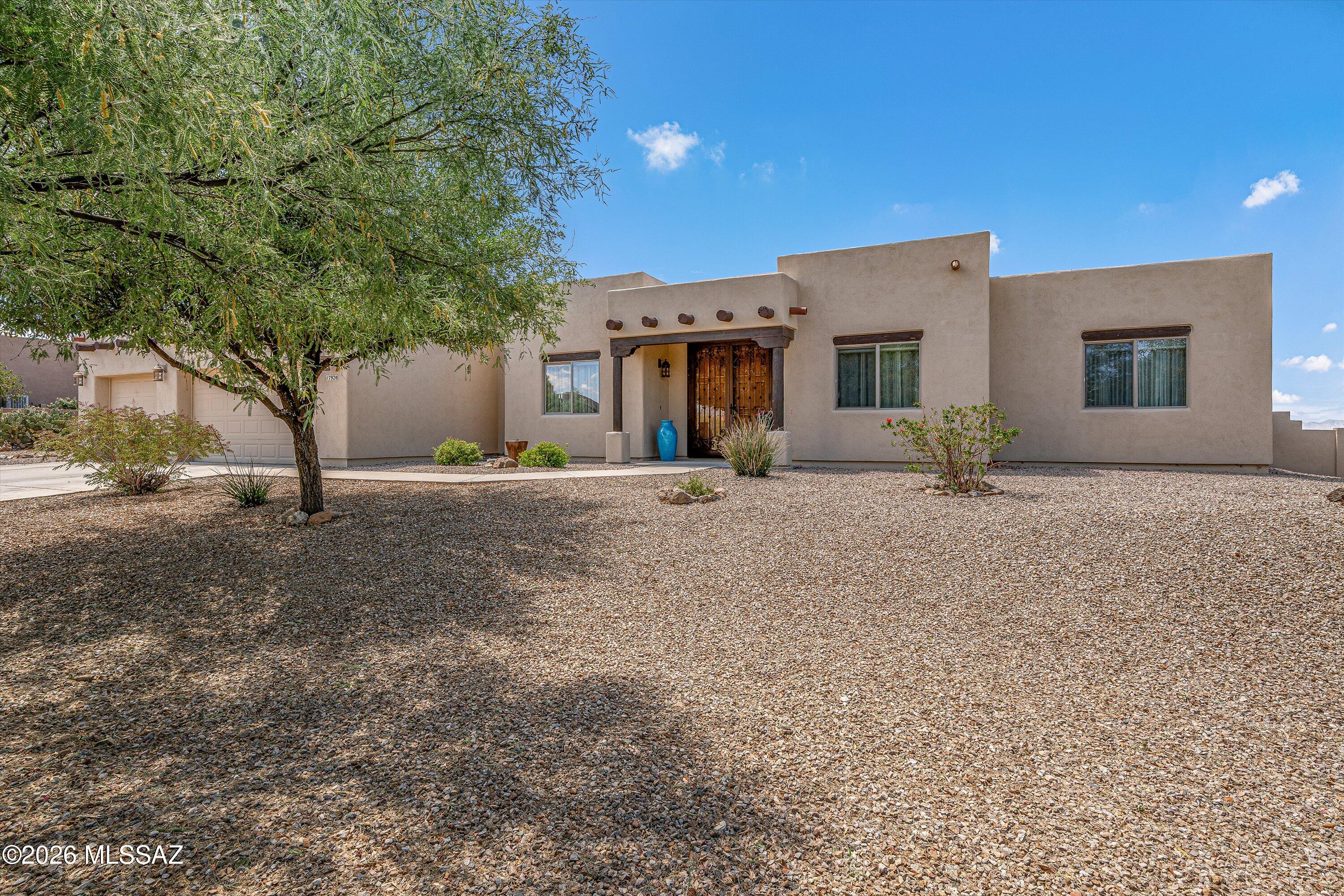 Beautifully maintained, spacious 3-bedroom plus den, 2-bath home offers 2,300 sq ft of comfortable living on a generous 0.71-acre lot. Located in a gated community with amenities including a pool, spa, basketball court, and jogging path. A welcoming double-door entry with custom security doors leads into a bright, open floorplan featuring designer paint, elegant arched details, and tile flooring throughout most of the living areas. The family room is anchored by a beehive fireplace. The eat-in kitchen is well-appointed with stainless steel appliances, a gas range, granite countertops, and a breakfast bar with seating. A sliding glass door opens to the extended patio, perfect for indoor-outdoor living and entertaining. The split floorplan includes two guest bedrooms connected by a convenient Jack-and-Jill bath, plus an additional guest bath with direct backyard access. The primary suite offers a private retreat with its own patio slider, dual vanities, soaking tub, and a separate shower. Additional highlights include a 3-car garage and a laundry room with utility sink and storage. Step outside to a low-maintenance backyard featuring a BBQ area, vista fencing, and breathtaking mountain views--with no neighbors behind for added privacy. All of this located within the highly sought-after Vail School District.