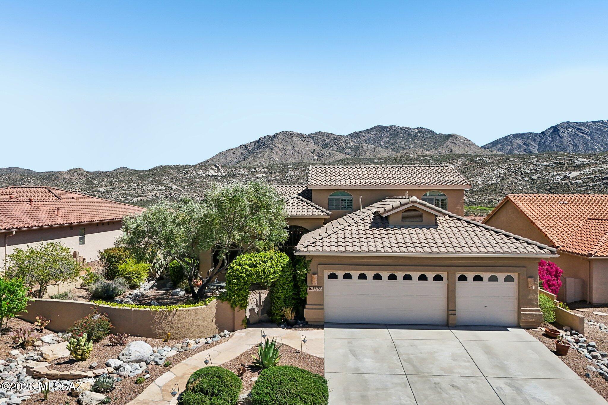 This is the home you've been waiting for.  If views are at the top of your list, this one is not to be missed.  Two patio posts were removed to open up the covered patio and large slider with floor to ceiling windows added to make the mountain views the focal point from both inside and out.  Durango floorplan includes a wonderful courtyard entrance with iron gate, flagstone, mature landscaping and new stained glass front doors. Inside, home features large kitchen with hickory cabinets, stainless appliances, granite countertops & center island with seating perfect for entertaining.  Kitchen opens to wonderful family room with gas fireplace, rustic wood mantle and just the right amount of southwest flair.  Oversized Primary bedroom with en-suite bath plus additional bedroom & full bath down stairs.  Formal living/dining and additional room perfect for office/den. 2 additional bedrooms/bath upstairs for your family/friends.  Step out into the backyard which includes a wonderful calming waterfall feature, firepit,  extended covered patio, citrus trees, total privacy and amazing mountain views.  Enjoy coffee in the morning and end the day winding down with the sun reflecting pink hues off the Catalina's.  3 car garage provides additional space for golf cart or hobbies.  Start enjoying your retirement lifestyle today in Saddlebrooke with this special hard to find home.