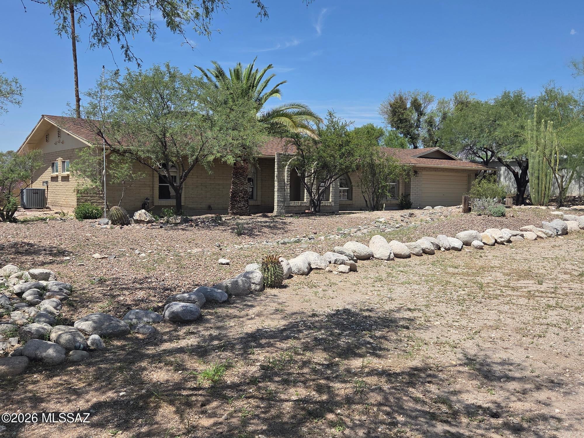 Prime Location & Spacious Living. Enjoy a great location close to shopping, schools, Sabino Canyon, and the River Walk Trail. Set on a desirable over-half-acre lot, this four-bedroom home offers plenty of space, privacy, and flexibility. One bedroom is thoughtfully designed as a home office, complete with a custom work center. The remodeled kitchen features abundant cabinetry and generous pantry storage. The primary suite includes a walk-in closet, built-ins, and a private attached bath. An oversized garage with a separate storage room provides plenty of room for vehicles, tools, and hobbies. Outside, the huge backyard is surrounded by mature vegetation and features a double gate with space for RV parking, a future workshop, or simply enjoying extra privacy and separation from neighbors.