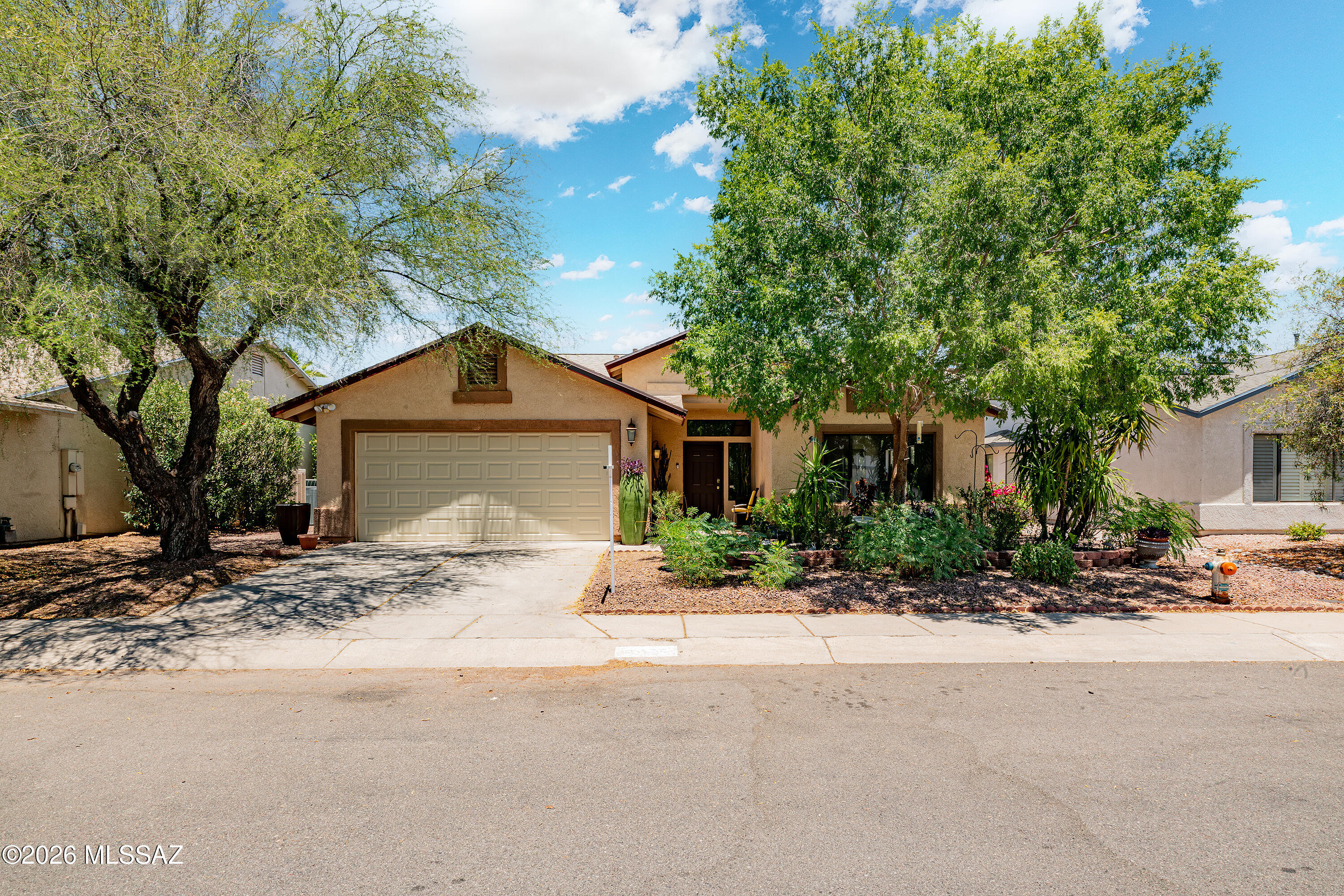 Nestled on a premium cul-de-sac lot in desirable Northwest Tucson, this original-owner 4-bedroom, 2-bath home showcases pride of ownership throughout. Fresh interior paint, updated electrical and lighting fixtures, and new ceiling fans create a bright, move-in-ready living space. Solar panels provide energy efficiency and added savings. The front yard features attractive desert garden, while the expansive backyard is designed for entertaining with artificial turf, pavers, a pergola, and a cozy fire pit gathering area. With plenty of room to relax, play, and host guests, the outdoor space is a true highlight. Located in a highly rated school district and convenient to shopping, dining, parks, and recreation, this exceptional home offers comfort, style, and ideal Northwest Tucson location.
