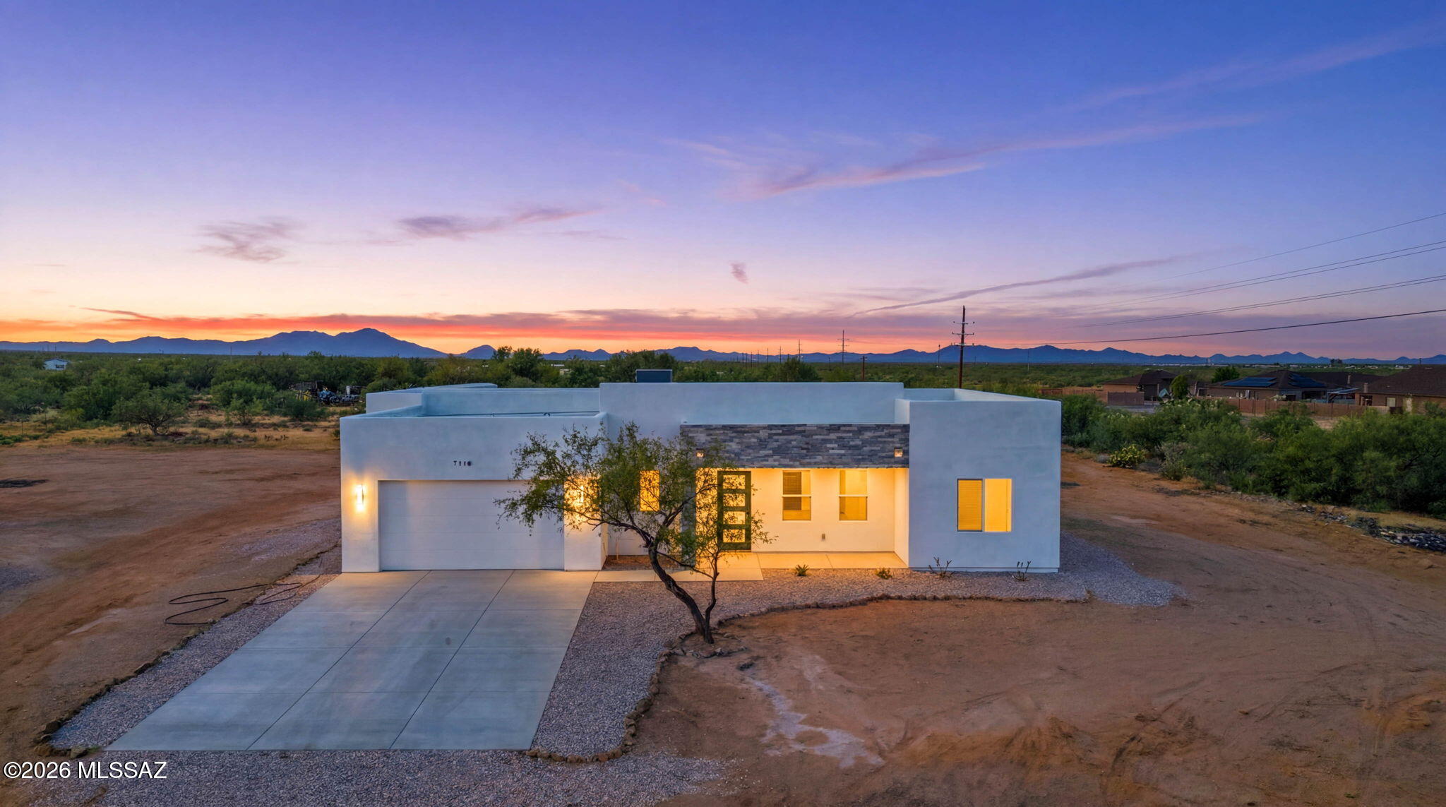 Beautifully designed contemporary home offering modern luxury, an open-concept floor plan, and high-end finishes throughout. This move-in ready residence features a spacious great room with a dramatic floor-to-ceiling porcelain accent wall, sleek electric fireplace, and abundant natural light. The gourmet kitchen showcases premium Taj Mahal quartzite countertops, stylish cabinetry, and a functional layout ideal for everyday living and entertaining. The private primary suite offers a spa-inspired retreat with a freestanding soaking tub, oversized walk-in shower, dual vanities, and designer details. Additional highlights include large-format tile flooring, a finished epoxy garage, and quality craftsmanship throughout. Enjoy the comfort, style, and value of a newly built home.Owner/Agent