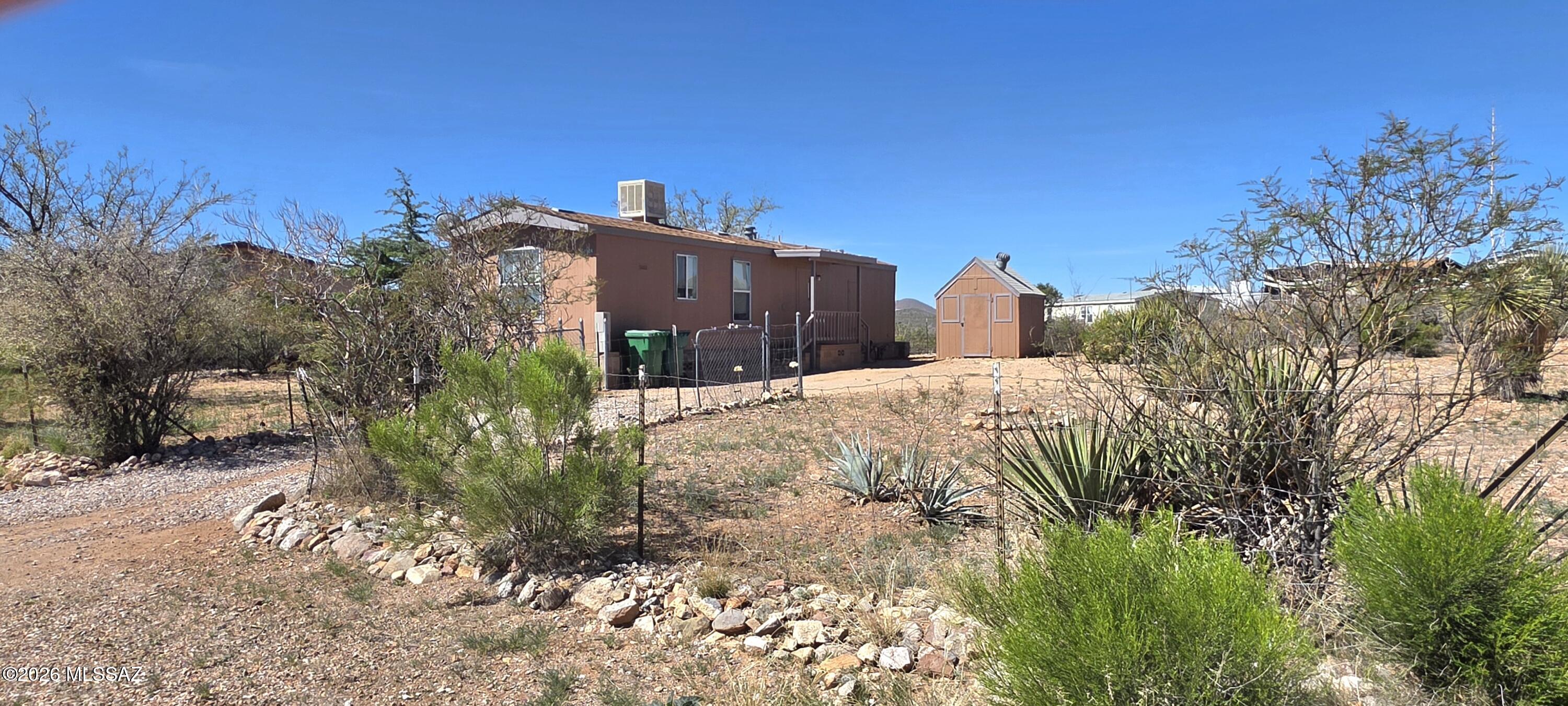 Two bedroom, one bathroom home in a quiet residential neighborhood. The yard is fenced and there is an outbuilding for storage. There is a 5.75X 23 foot unheated bonus room. Just minutes from the heart of Tombstone.