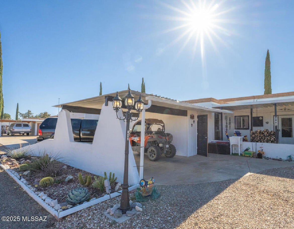 Lovely townhome in historic town of Pearce. This townhouse has the most gorgeous views looking toward the mountains. It shows beautifully and all the flowering is just getting started.  The primary suite opens to an enclosed covered patio. The home has tiled floors, newer bathrooms, renovated kitchen, and a woodburning fireplace in the living room. An additional covered patio at the back to enjoy, as well. Two car carport, workshop storage, laundry, and more. This beauty is move-in-ready. The outside is immaculately clean with pine trees and AZ desert landscaping. It is pride of ownership. A must see! CONV,  USDA, VA, FHA, Cash