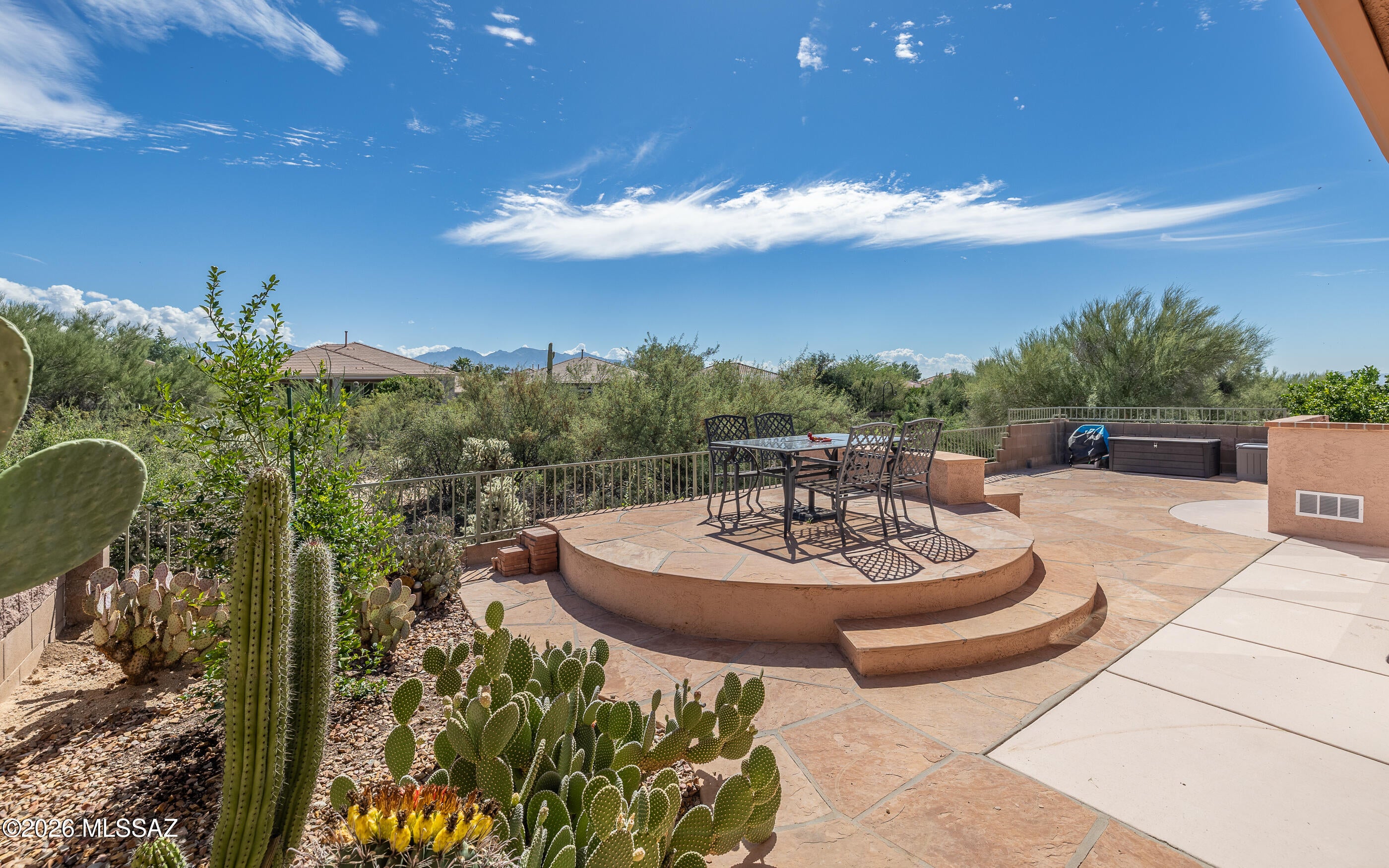 The largest sf of any townhome in The Highlands - this very spacious grand great room style home hosts wonderful nature and mountain views. Backs to a common area desert/wash w/nice privacy & view fencing. Completely fenced property -from the gated front entry walkway to roomy backyard. There is also a walled front courtyard for relaxation and neighborhood gatherings.  Very nice sized kitchen w/abundant cabinetry, granite counters and black appliances. ALL tile flooring. Multiple dining areas - spacious bedrooms. HVAC replaced roughly 4 years ago, water heater replaced approx 3 years ago. New Water Tec softener installed April 2025. Replaced belt drive garage door opener with a 3/4 HP motor March 2025.  All screes replaced by Screen Mobile in April 2024. Another plus - 4ft extended garage! Clothes dryer replaced appox 2 years ago. There is also a wall garage vent fan & storage cabinets. Guest bedroom is quite spacious with walled Murphy Bed and full wall built-in dual desk office station.